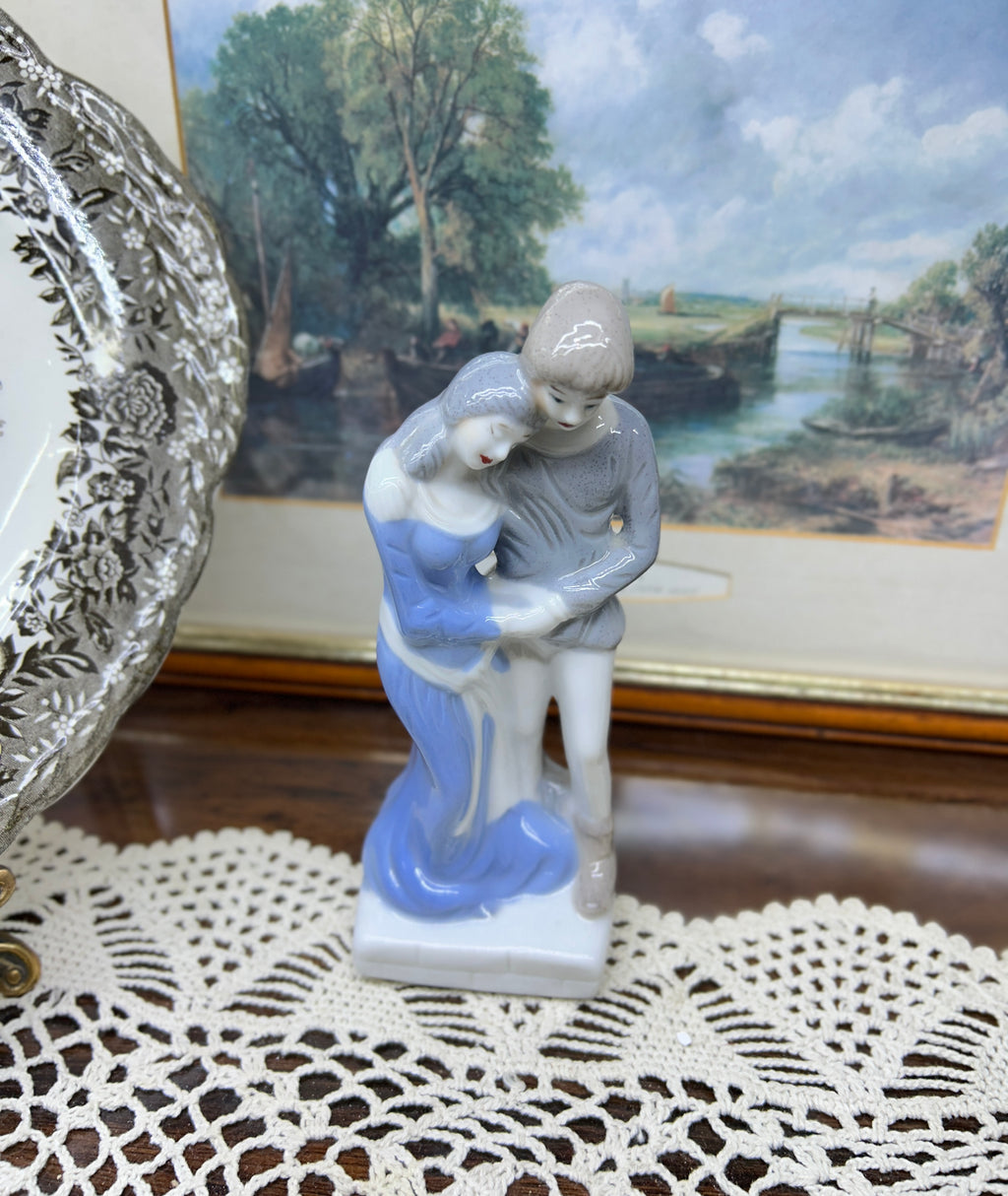 Vintage decorative glazed porcelain figurine depicting a young couple