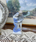 Vintage decorative glazed porcelain figurine depicting a young couple