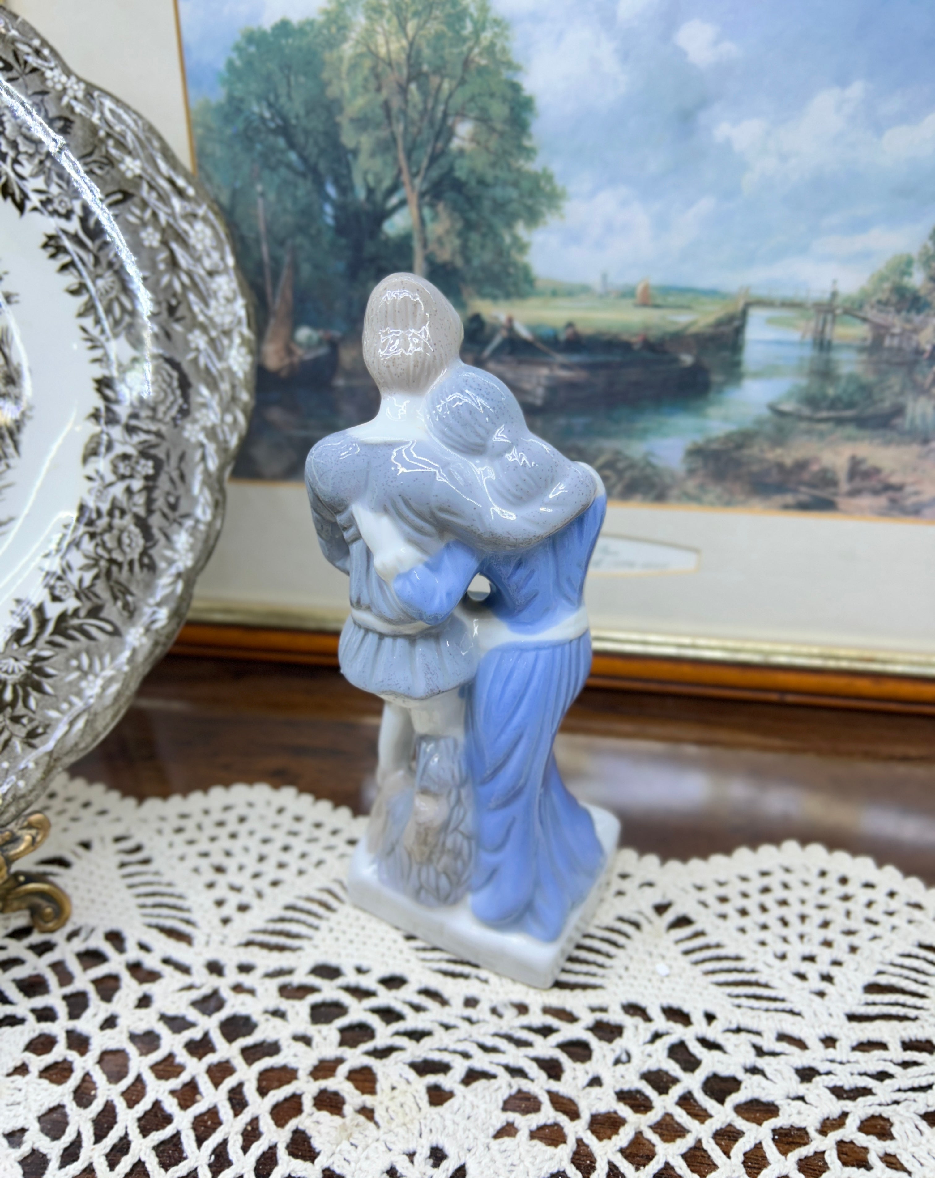 Vintage decorative glazed porcelain figurine depicting a young couple