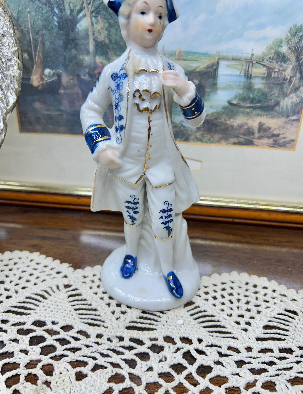 vintage porcelain  Colonial man figure — styled in blue and white with gold trim 6”