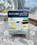 Woolworths Cook Essentials mechanical kitchen scale with a 5kg/11lb capacity — boxed