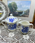 Vintage Shenango China teapot and matching creamer set featuring the iconic Blue Willow pattern.