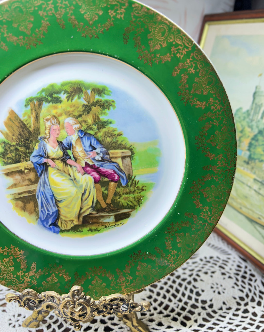 French porcelain display wall plate featuring a Fragonard courting couple scene 11”