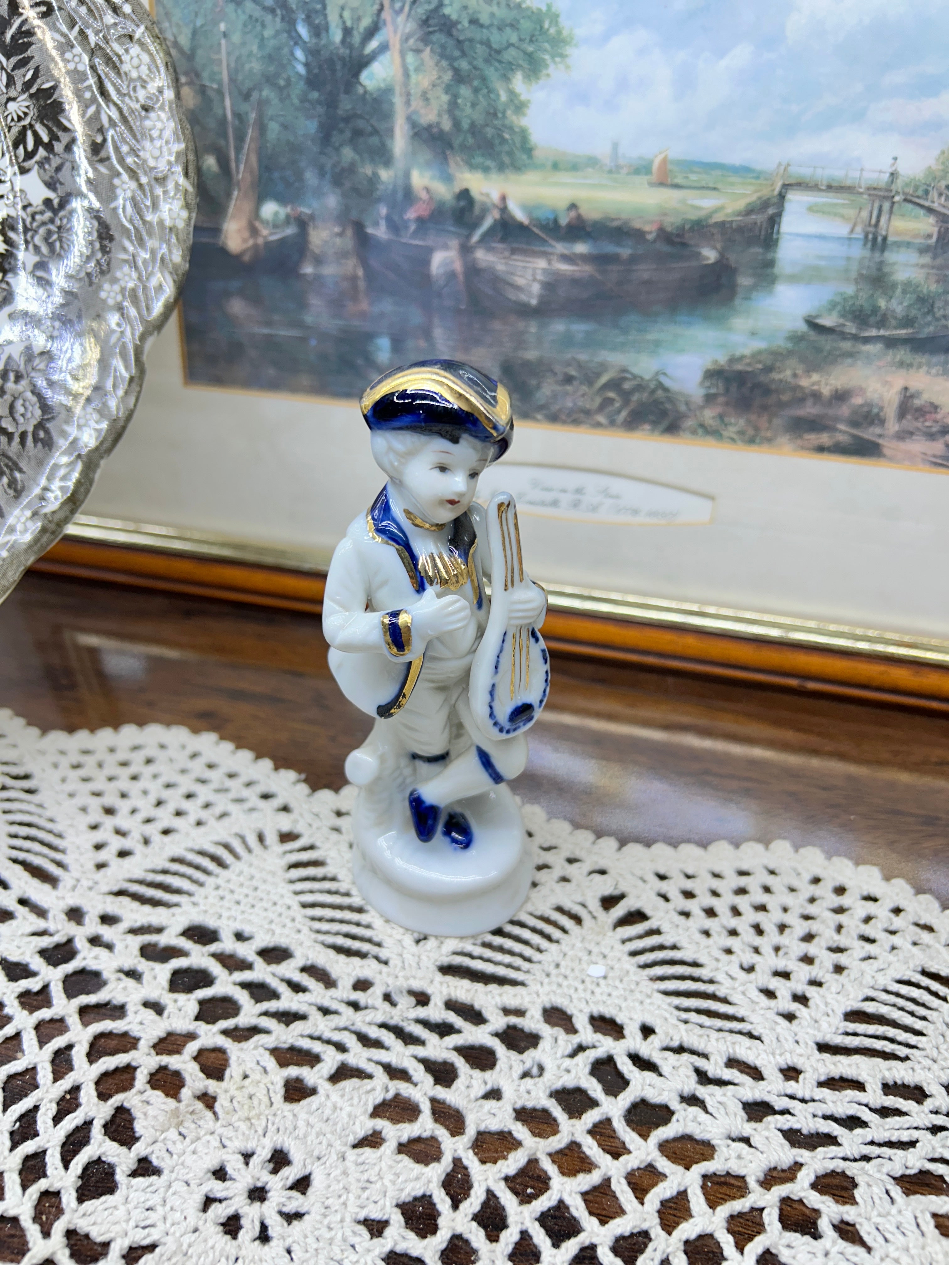 Vintage Capodimonte porcelain figurine features a boy playing a mandolin 5”