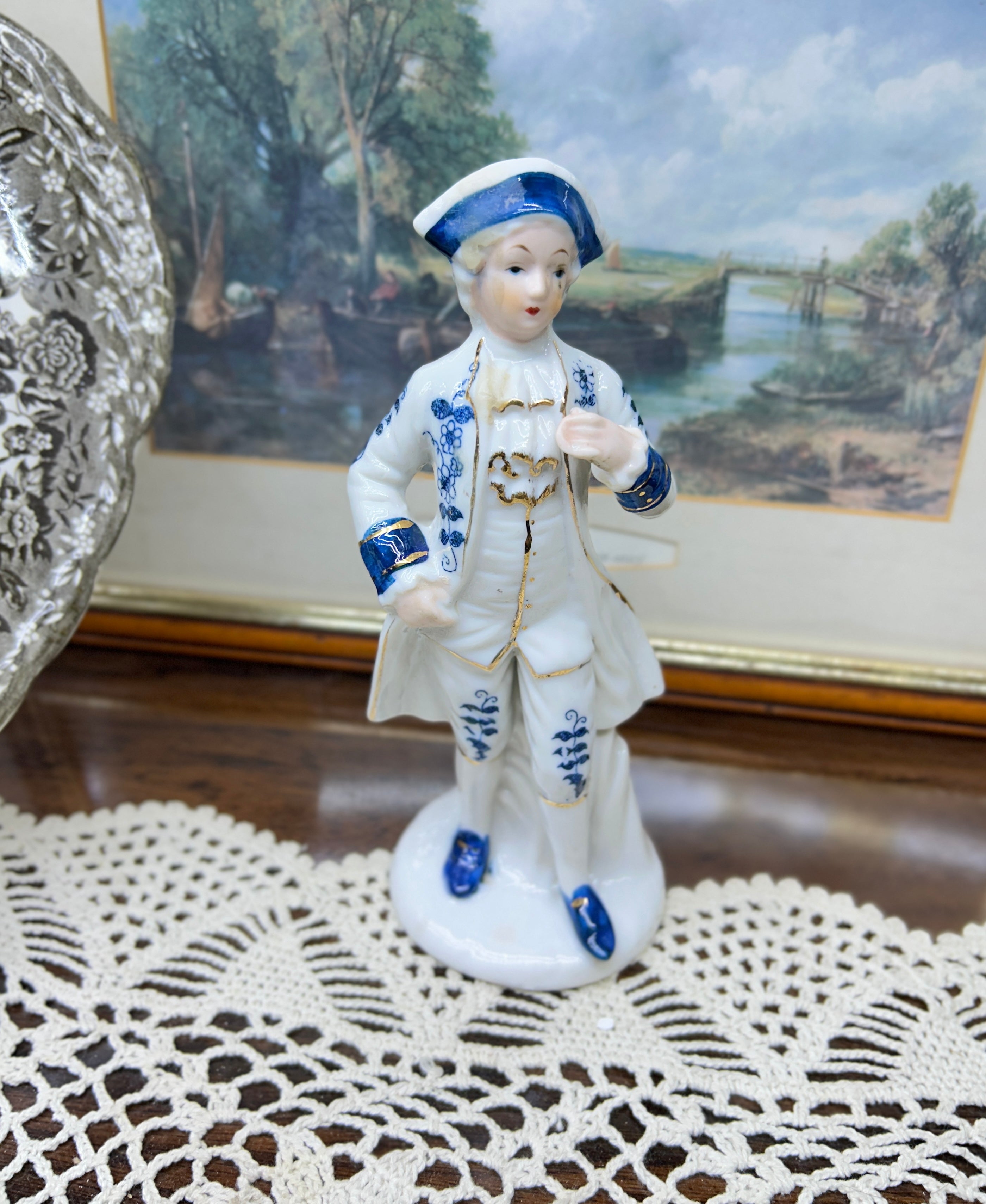 vintage porcelain  Colonial man figure — styled in blue and white with gold trim 6”
