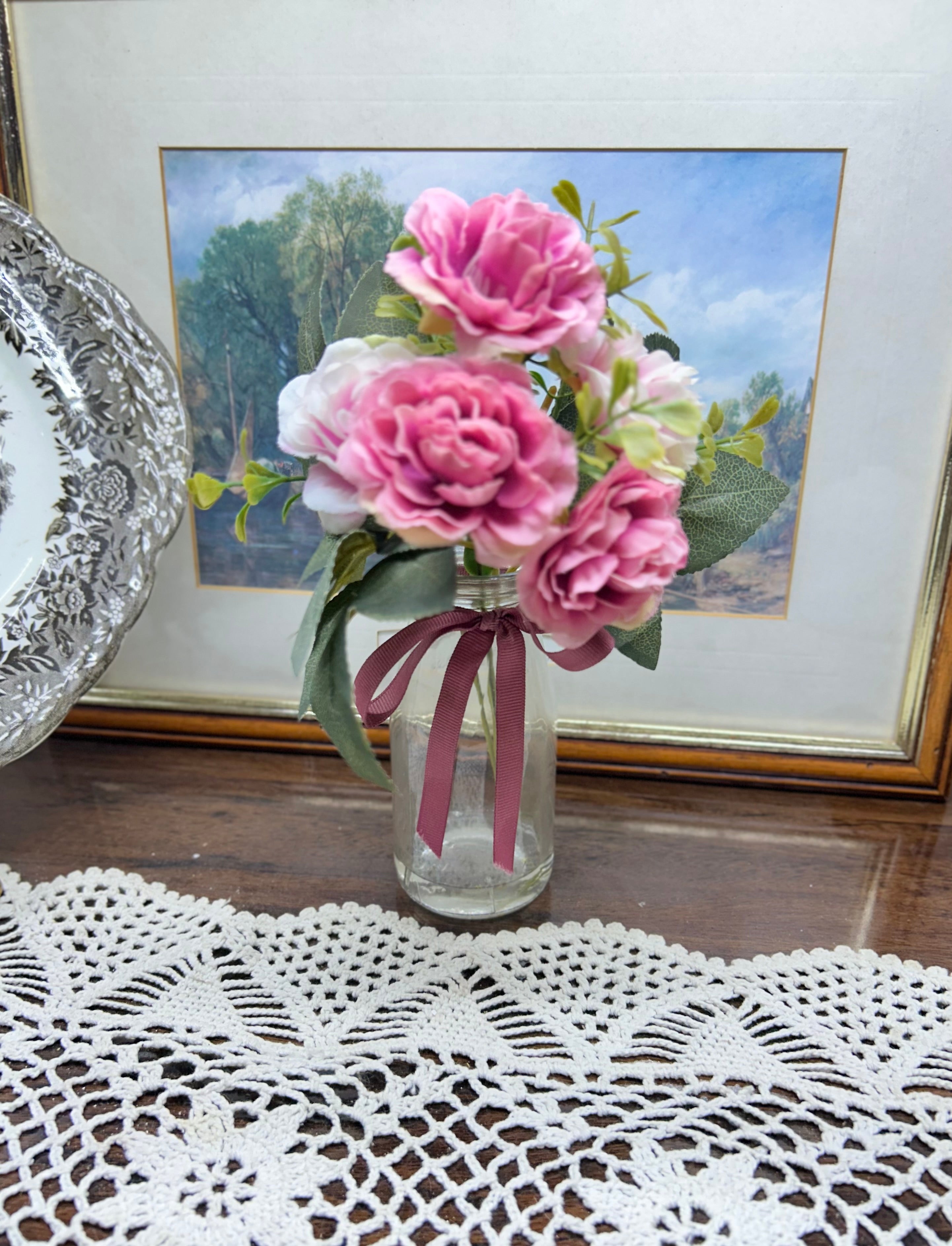 Decorative faux peonies arrangement in a glass gel vase