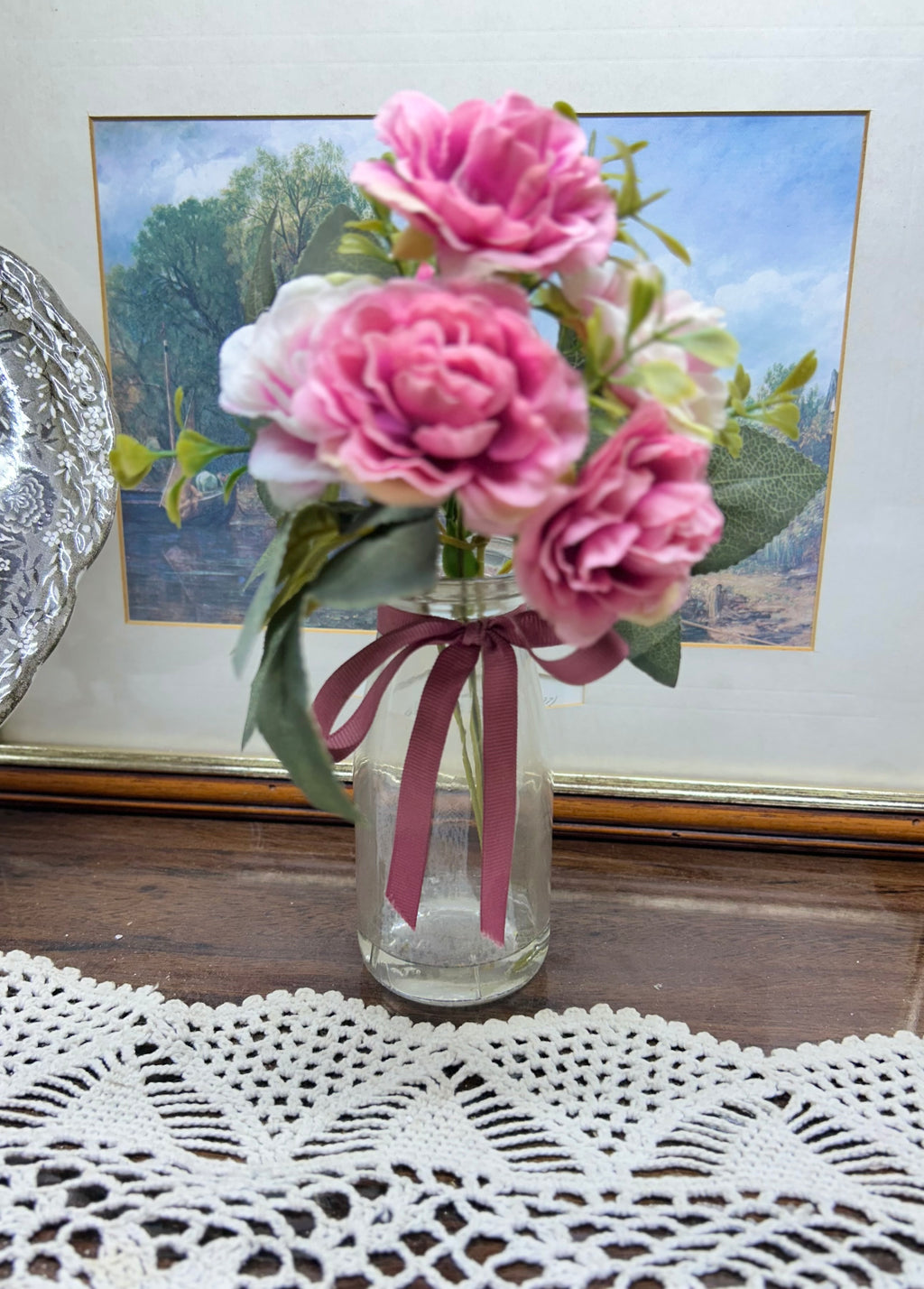 Decorative faux peonies arrangement in a glass gel vase