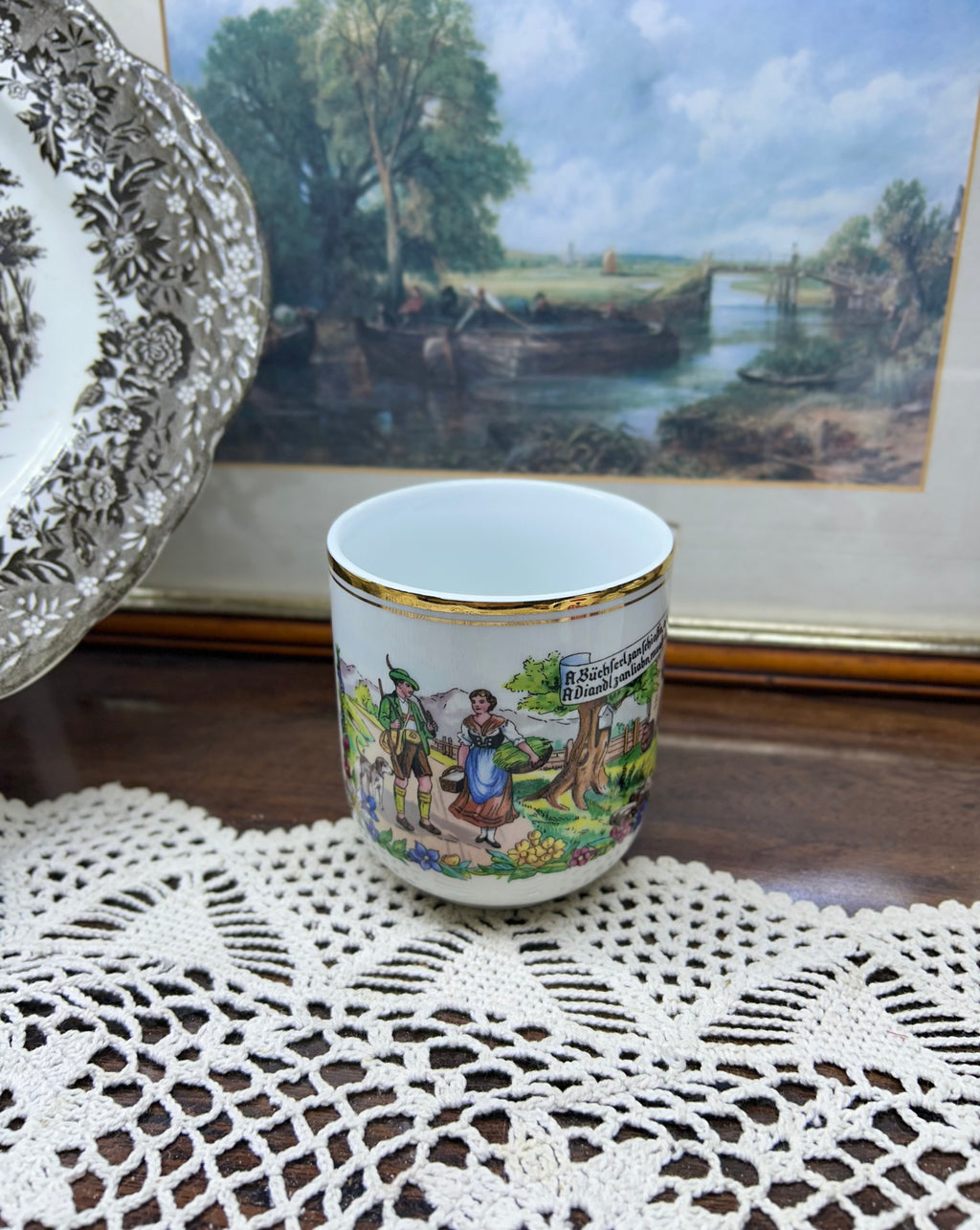 Vintage Austrian porcelain souvenir mug with a traditional folk scene — gold trim