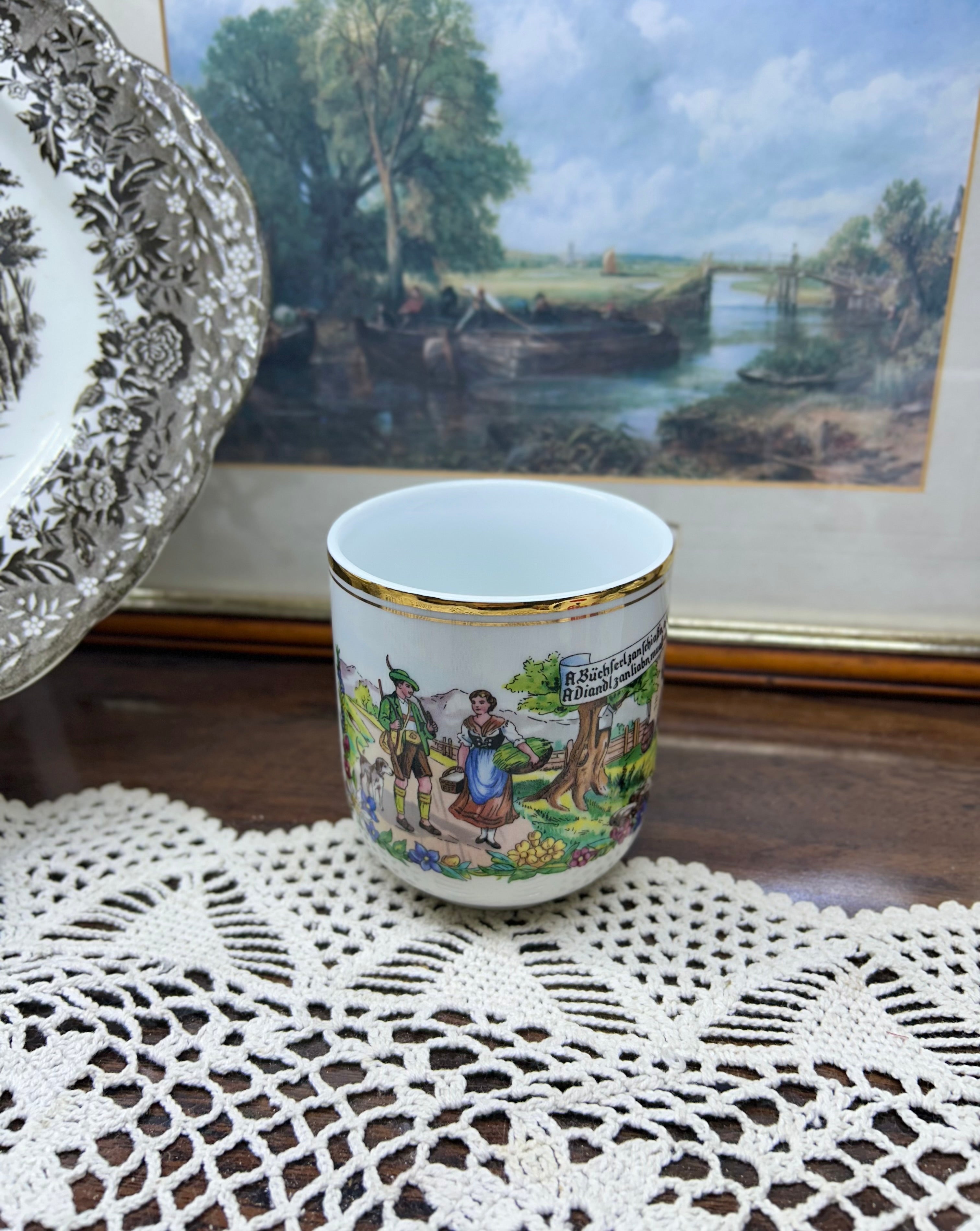 Vintage Austrian porcelain souvenir mug with a traditional folk scene — gold trim