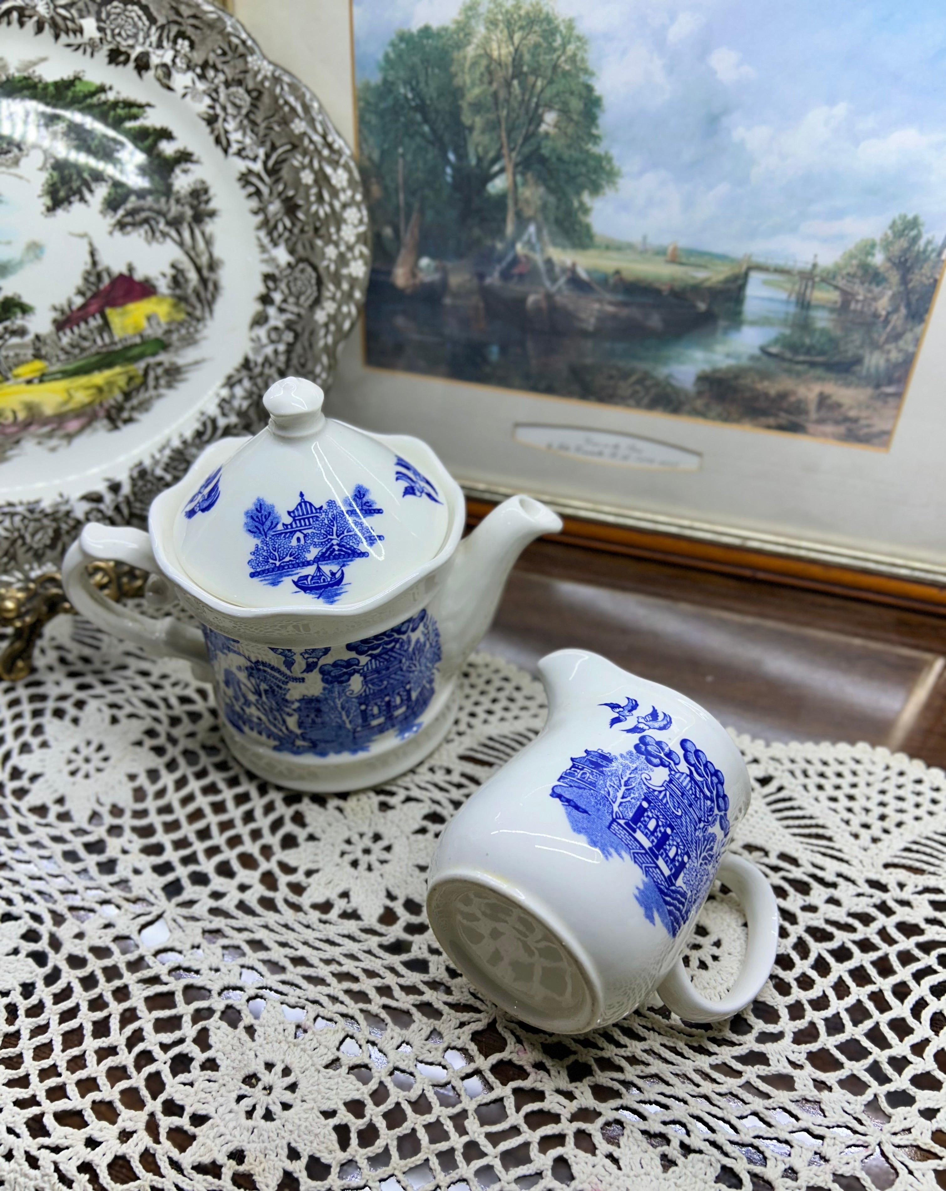 Vintage Shenango China teapot and matching creamer set featuring the iconic Blue Willow pattern.