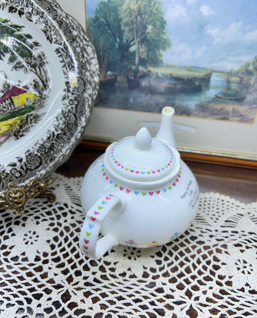 Vintage white ceramic teapot features a delicate heart garland design