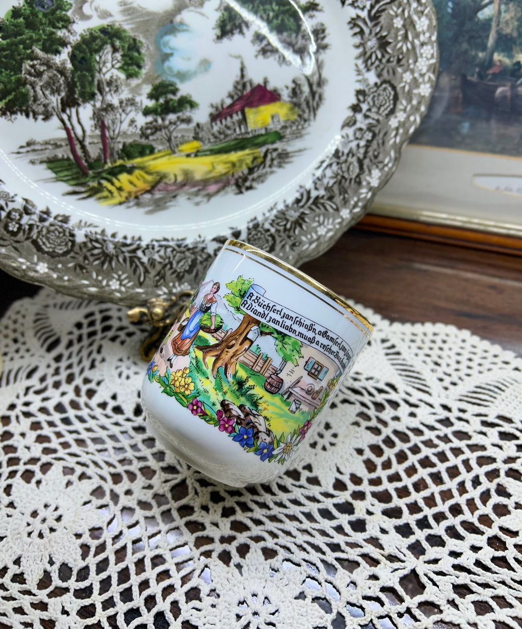 Vintage Austrian porcelain souvenir mug with a traditional folk scene — gold trim