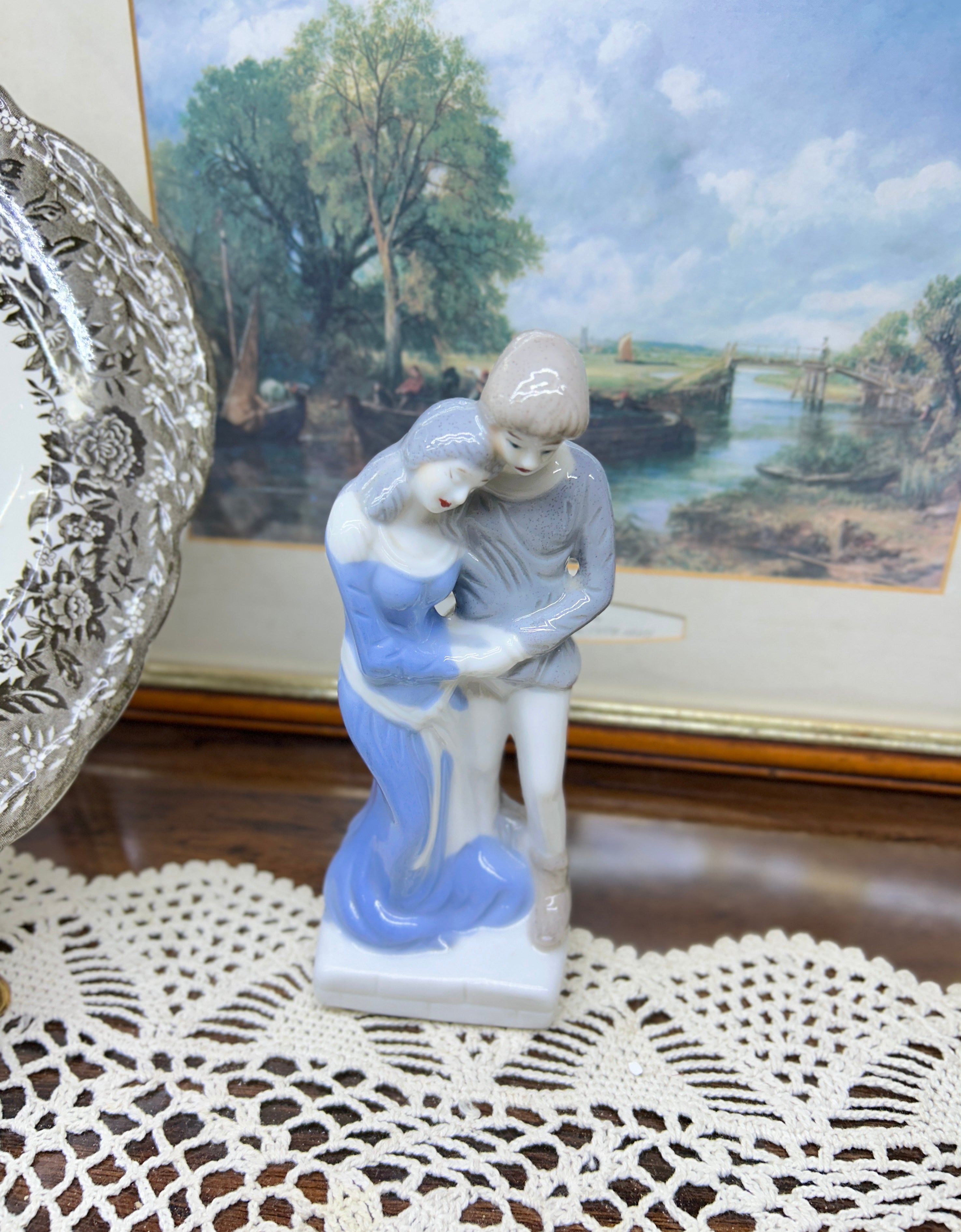 Vintage decorative glazed porcelain figurine depicting a young couple