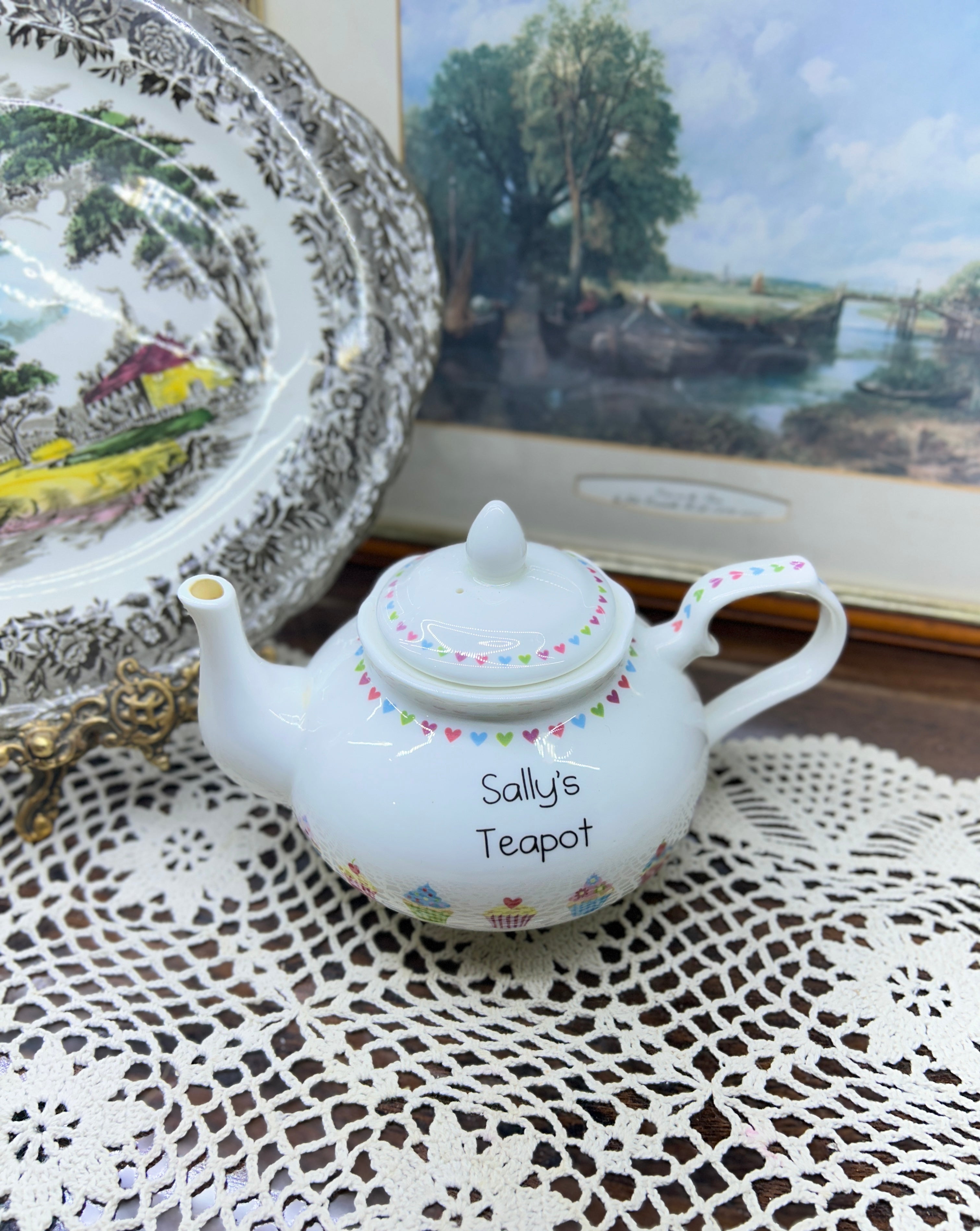 Vintage white ceramic teapot features a delicate heart garland design