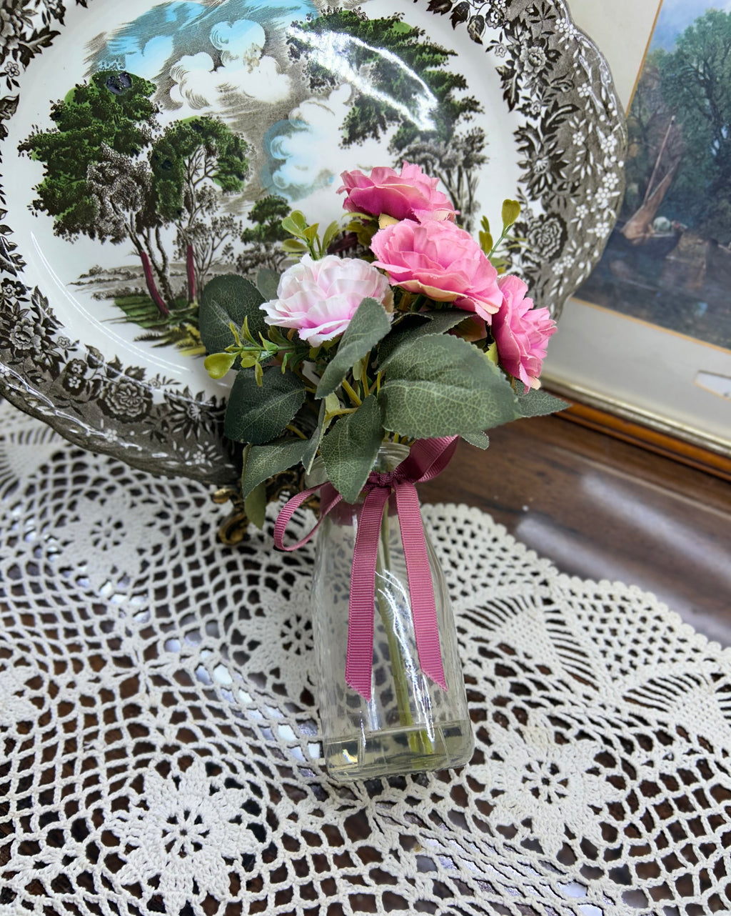 Decorative faux peonies arrangement in a glass gel vase
