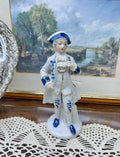 vintage porcelain  Colonial man figure — styled in blue and white with gold trim 6”