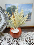 Harvest Home  orange pumpkin-shaped ceramic vase filled with dried pampas