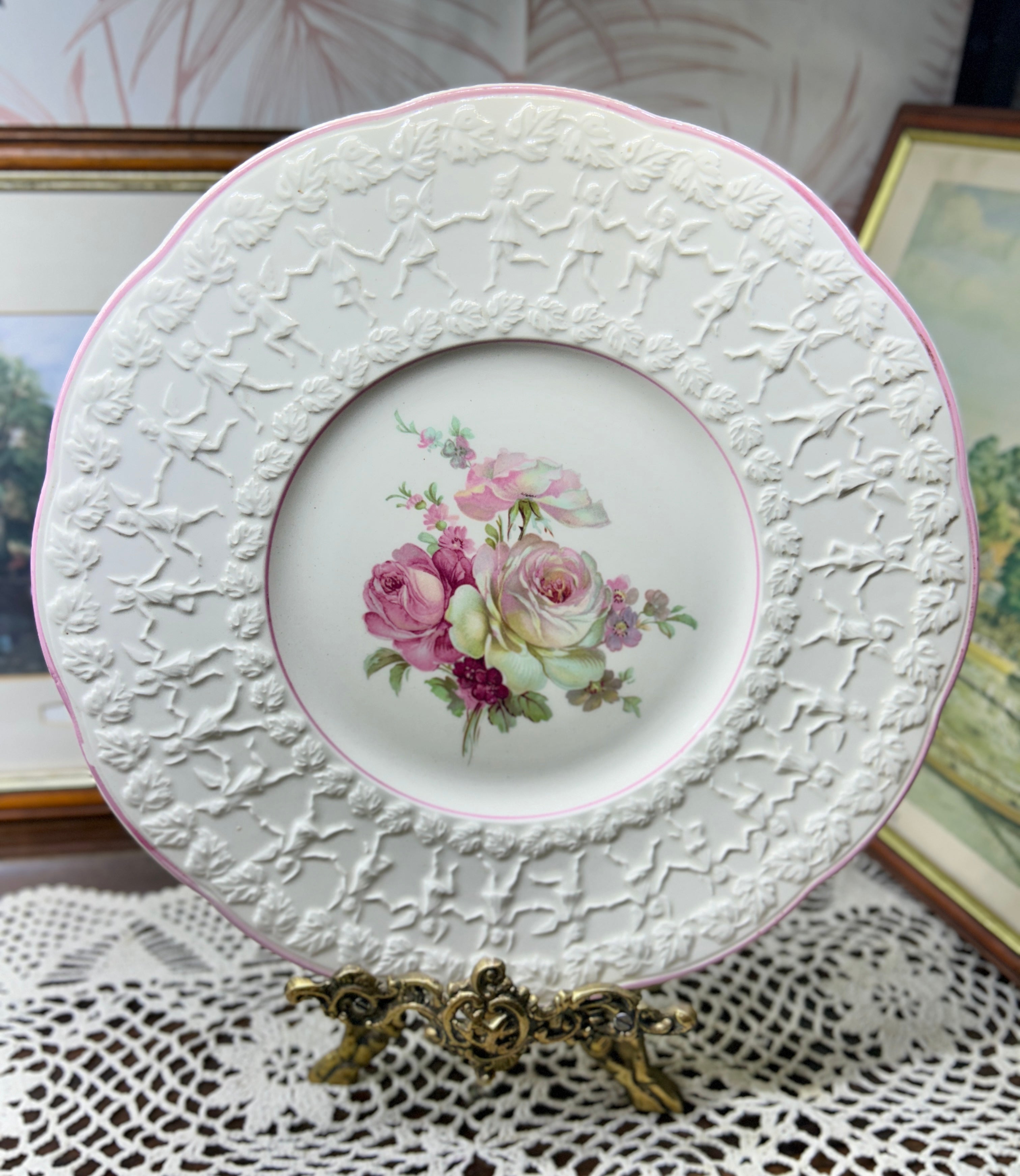 Vintage Crown Ducal Rose Marie pattern wall plate featuring a pink-tinted rim and a central rose bouquet 12”