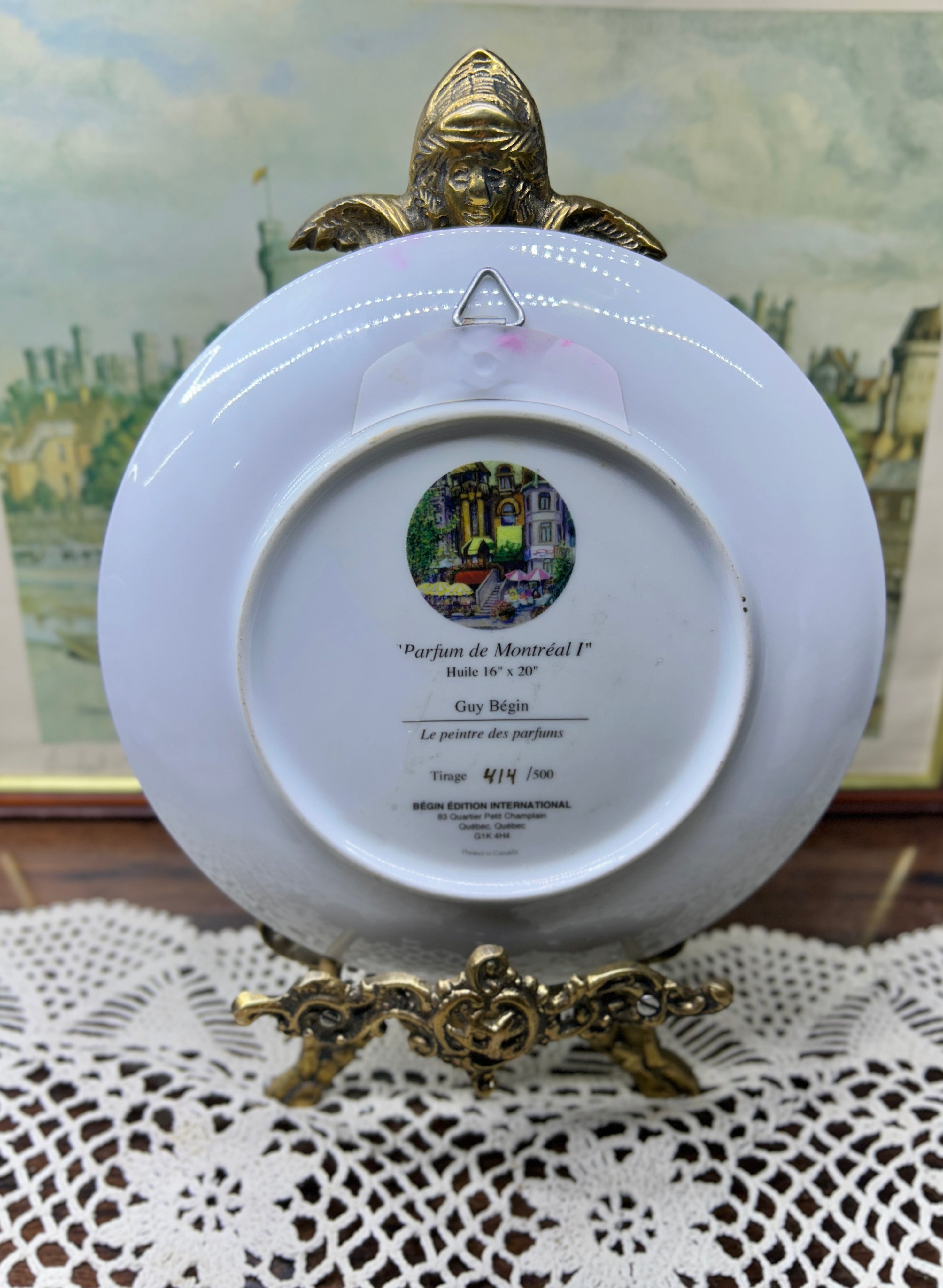 French wall decorative plate featuring a cityscape scene reminiscent of a French courtyard 7”