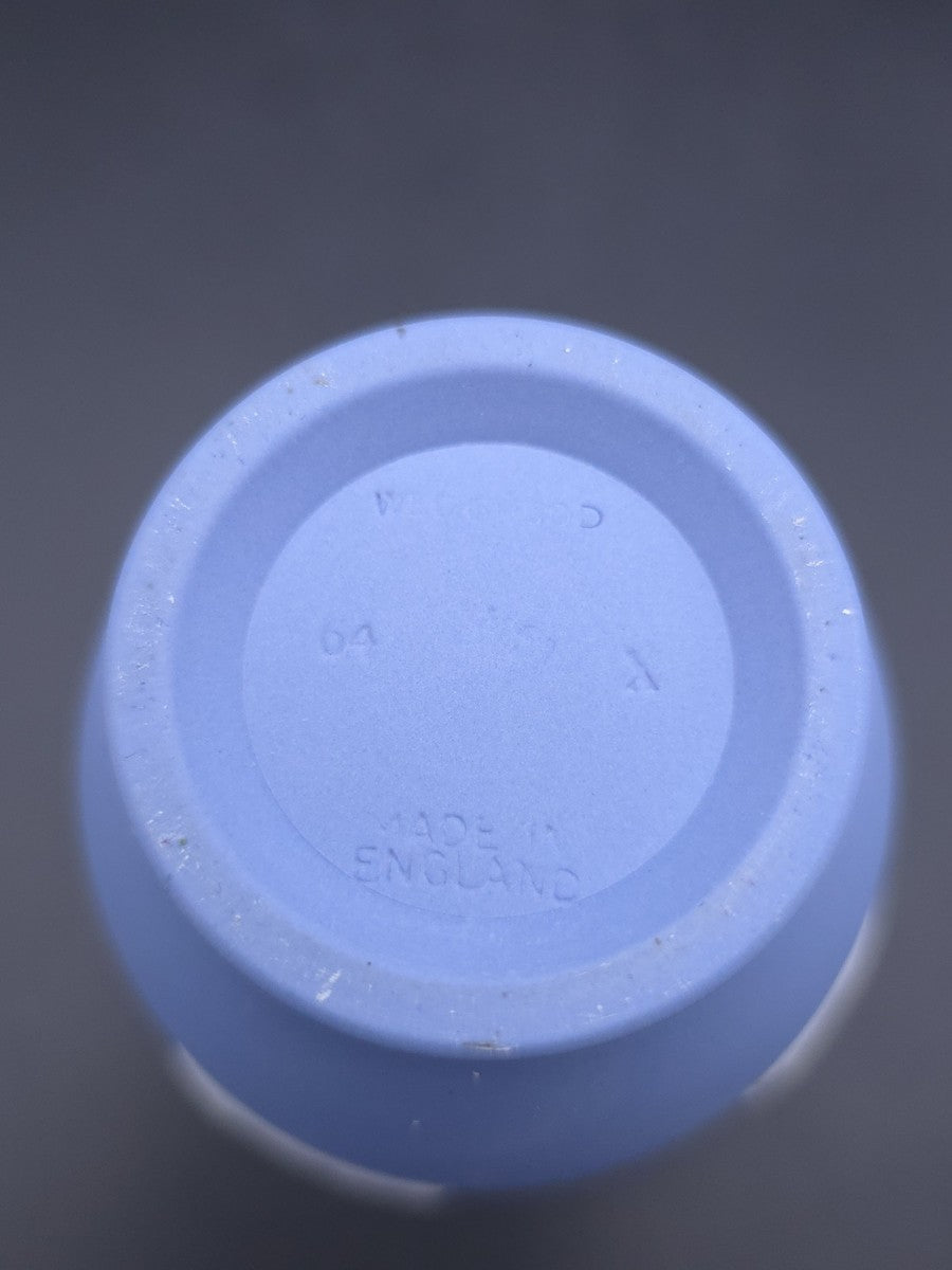 Vintage 1965 Wedgwood blue Jasperware bud vase — featuring white bas-relief cameo designs of classical figures or cherubs.