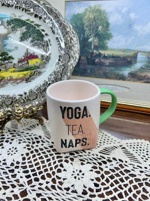 Ceramic mug featuring the slogan "YOGA. TEA. NAPS." — England