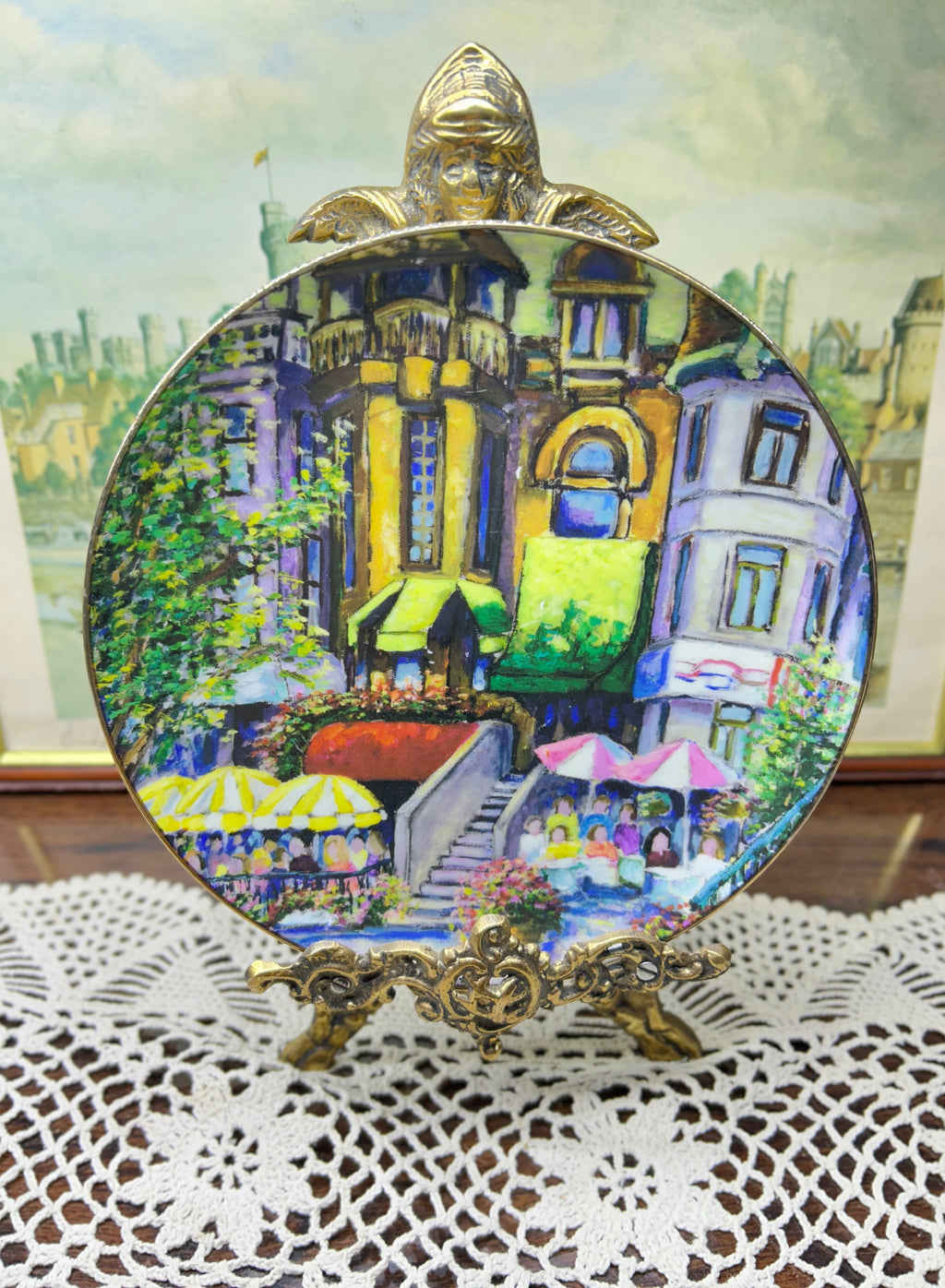 French wall decorative plate featuring a cityscape scene reminiscent of a French courtyard 7”