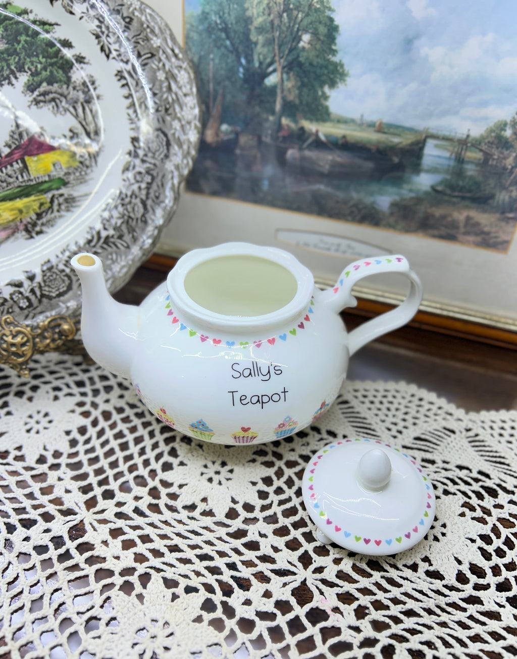 Vintage white ceramic teapot features a delicate heart garland design