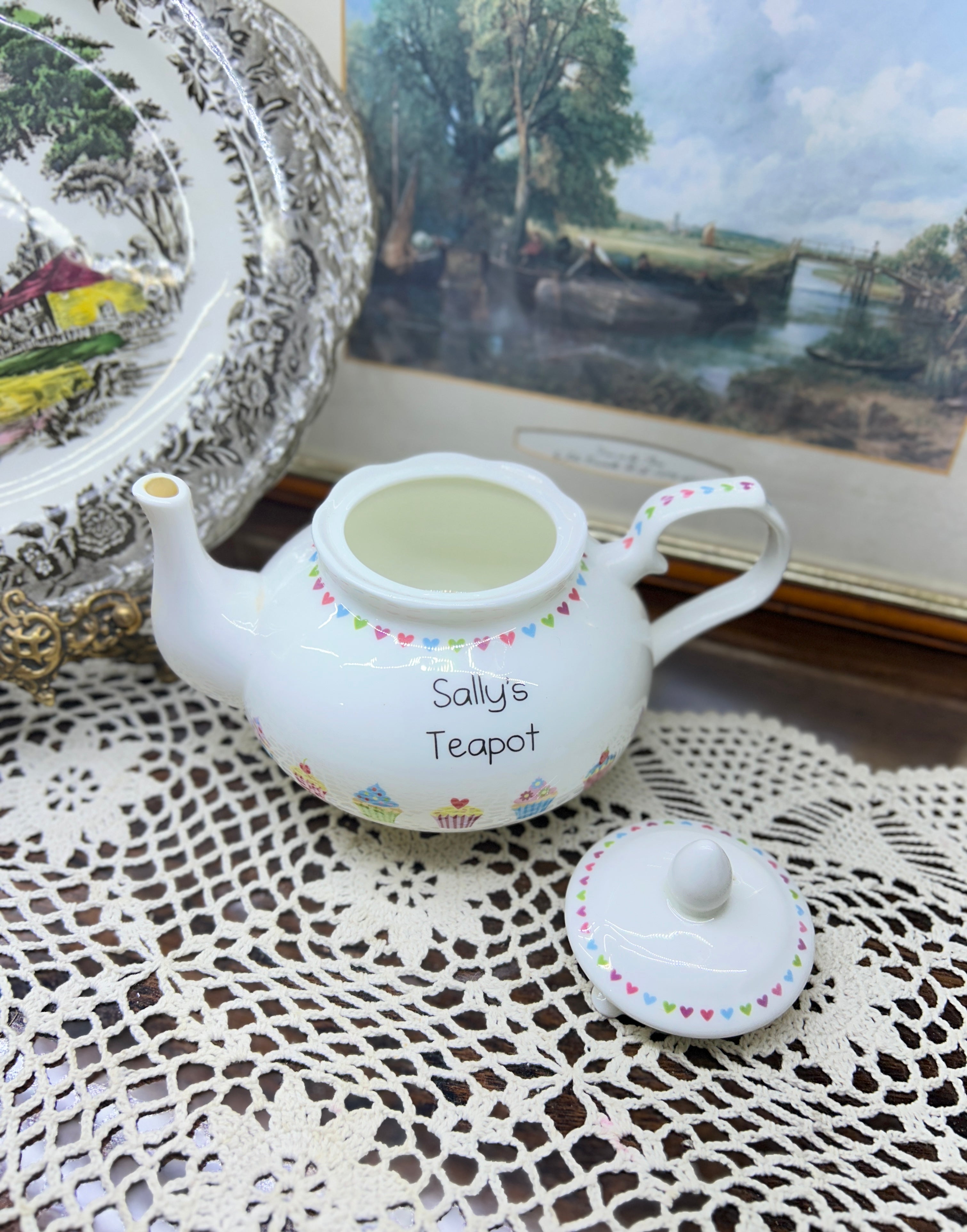 Vintage white ceramic teapot features a delicate heart garland design