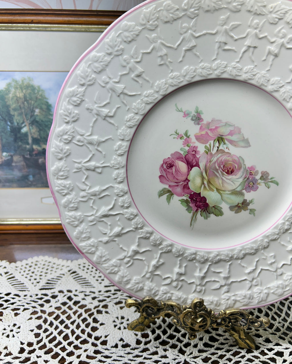 Vintage Crown Ducal Rose Marie pattern wall plate featuring a pink-tinted rim and a central rose bouquet 12”