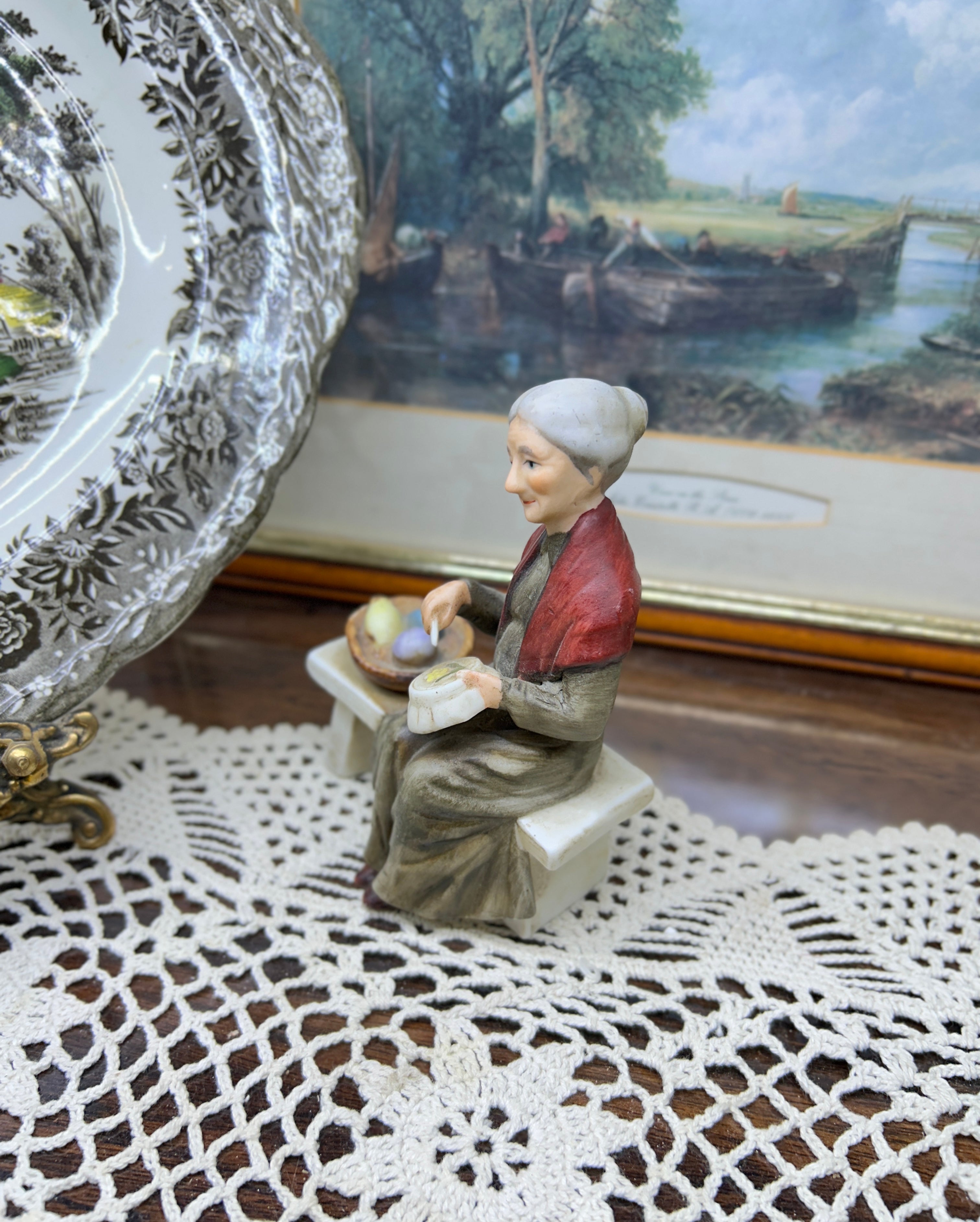 Vintage capodimonte figurine featuring an old lady sitting on a bench —  5”