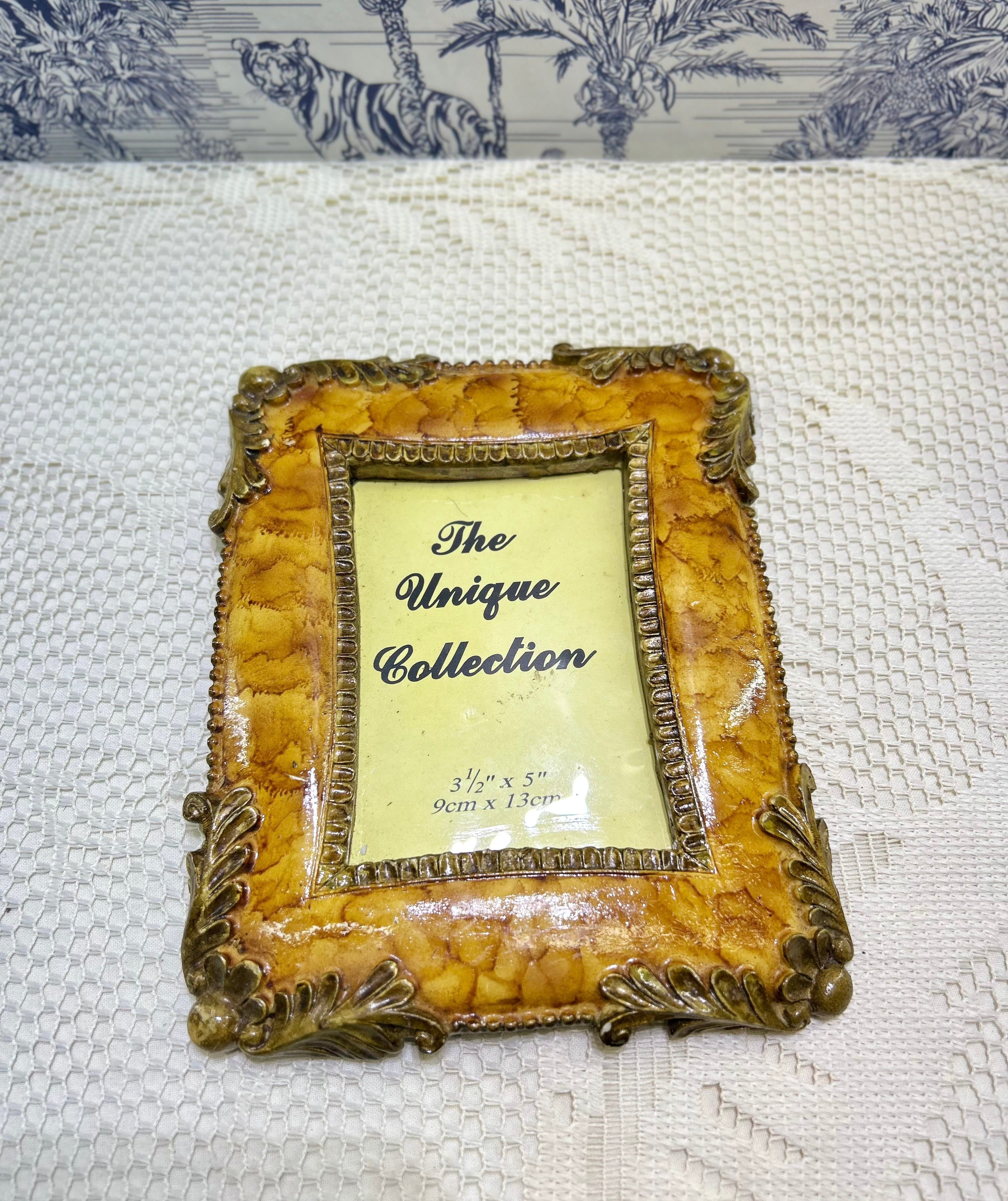 Resin photo frame with ornate antique gold border