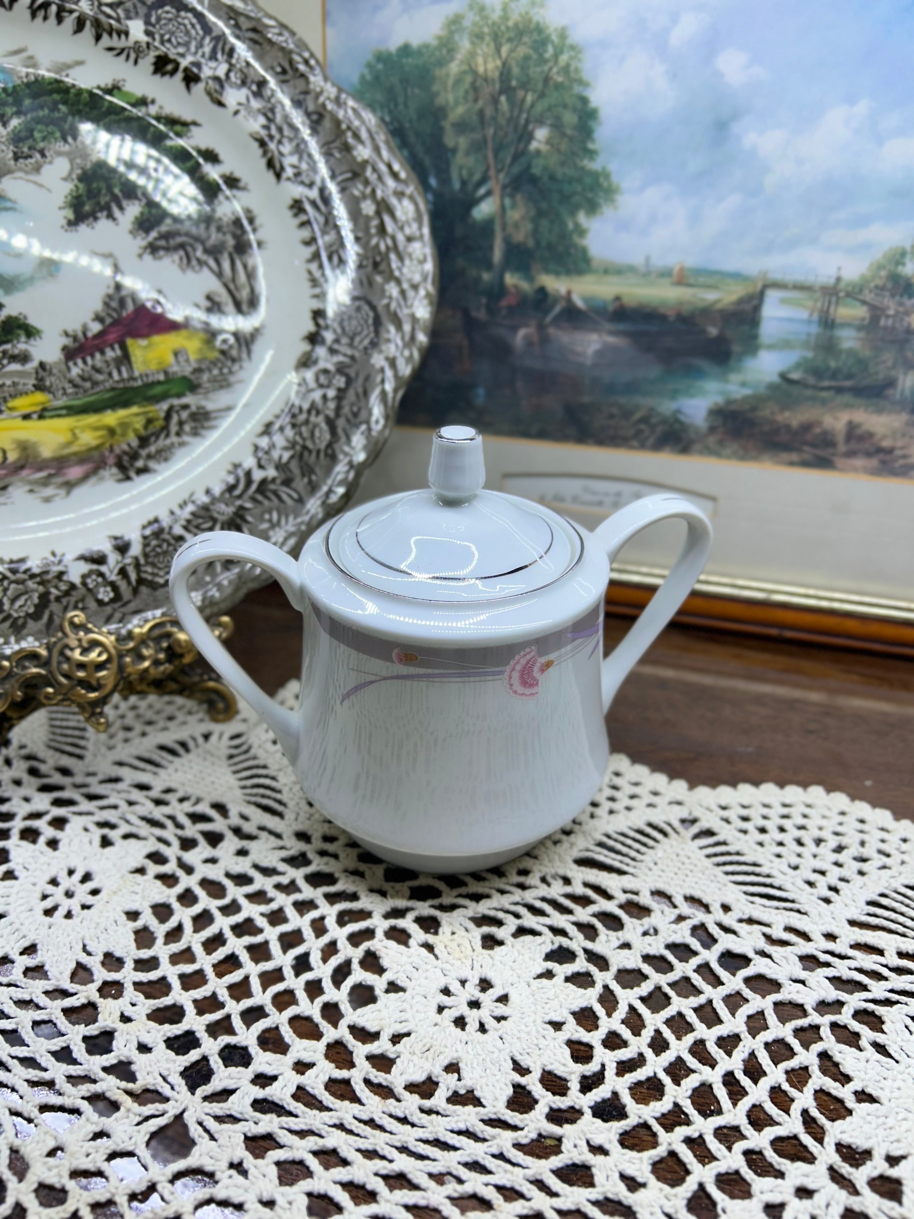 Vintage porcelain lidded sugar pot with silver rim
