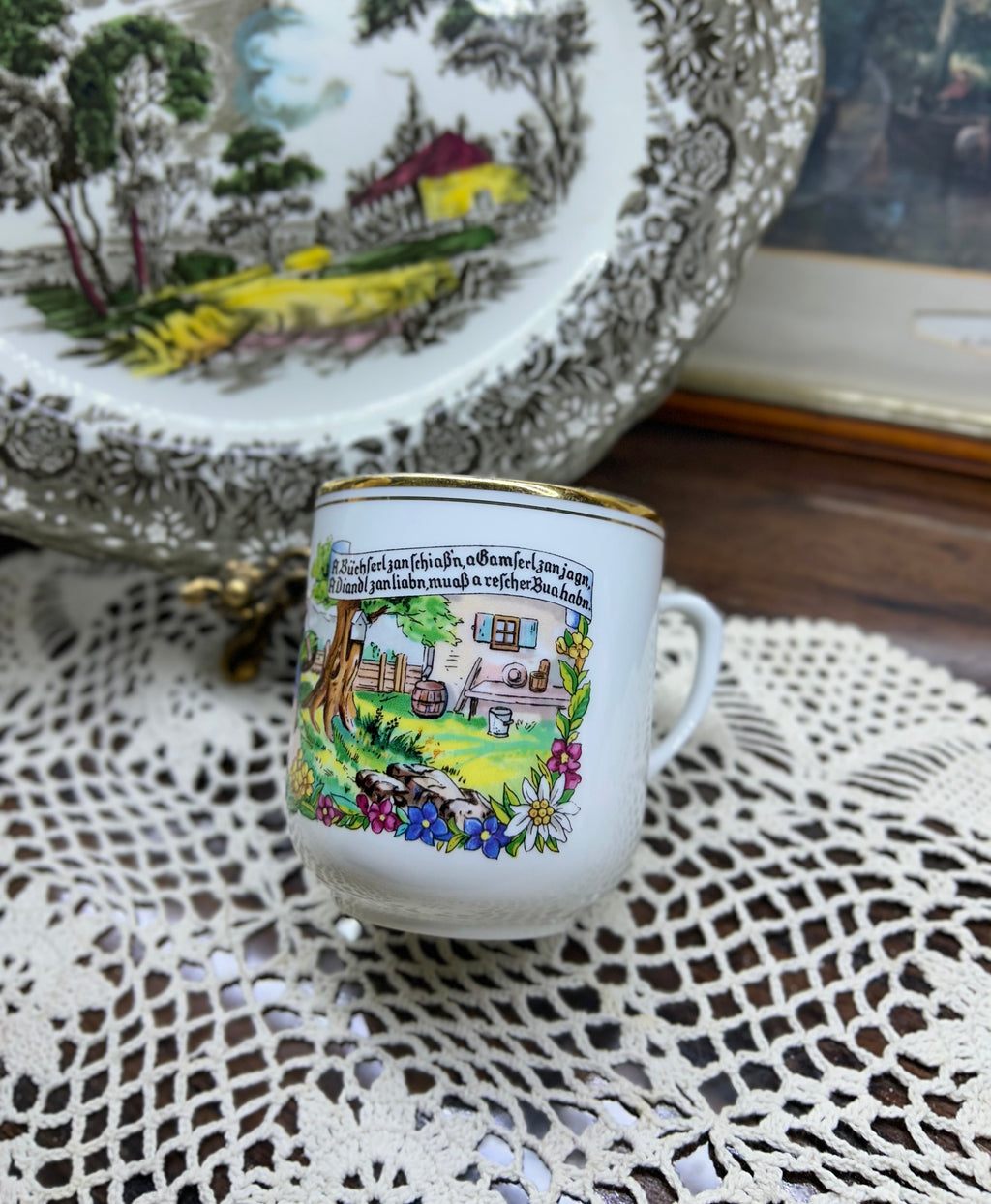 Vintage Austrian porcelain souvenir mug with a traditional folk scene — gold trim