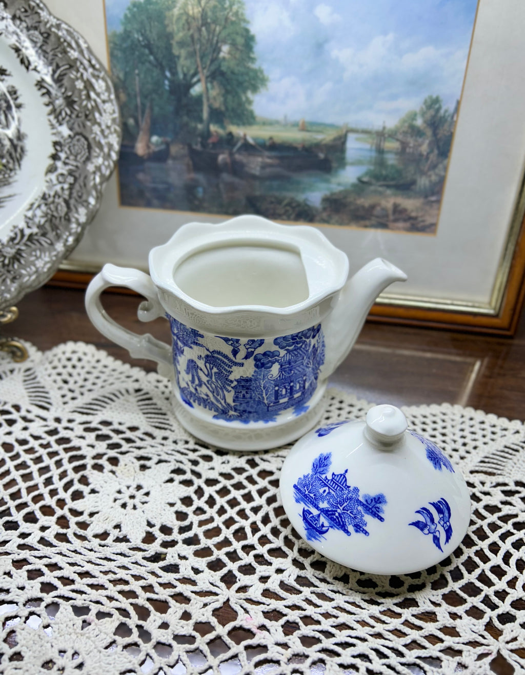 Vintage Shenango China teapot and matching creamer set featuring the iconic Blue Willow pattern.