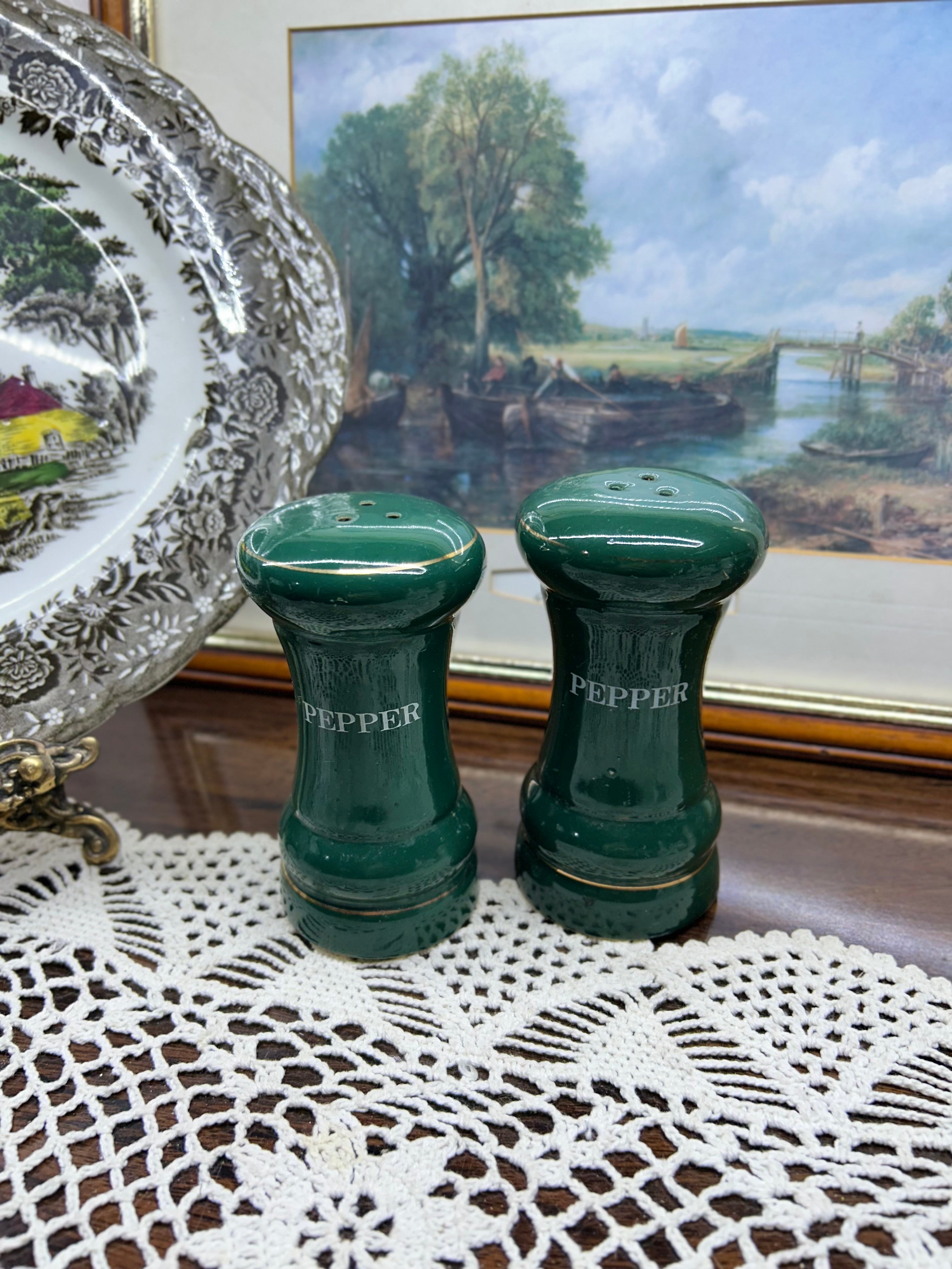 vintage green porcelain salt and pepper shakers feature gold trim and are labeled "PEPPER"