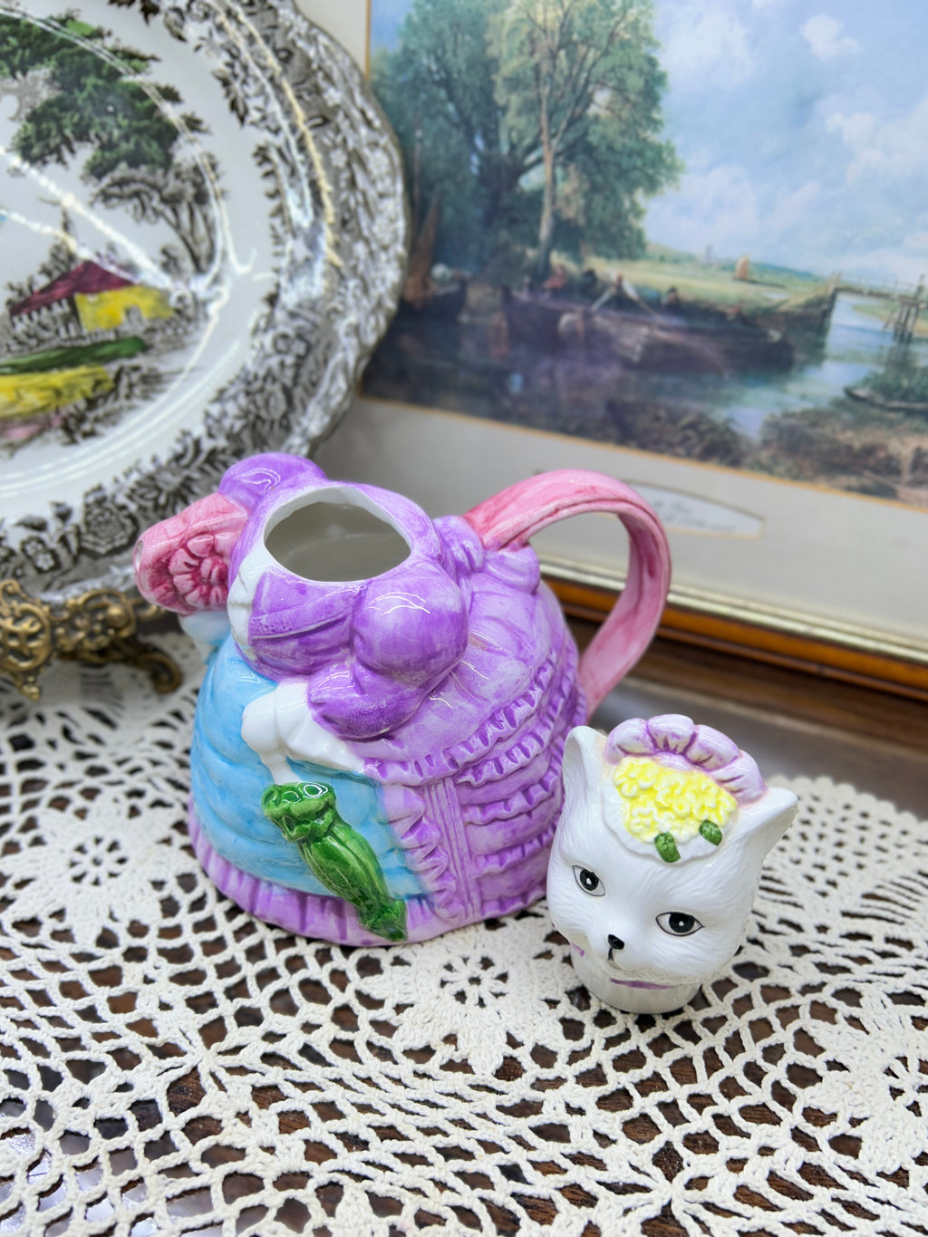 vintage ceramic novelty teapot featuring a cat dressed in a Victorian-style purple dress and bonnet 7”