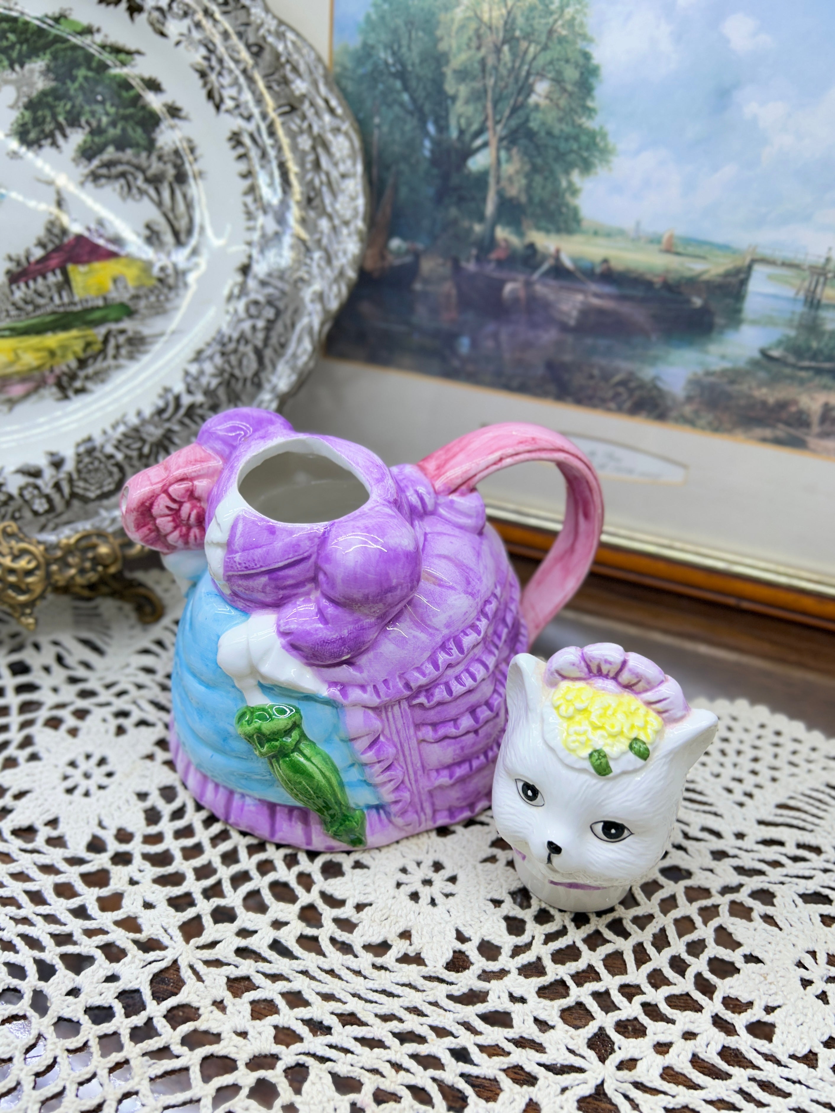 vintage ceramic novelty teapot featuring a cat dressed in a Victorian-style purple dress and bonnet 7”