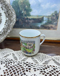 Vintage Austrian porcelain souvenir mug with a traditional folk scene — gold trim