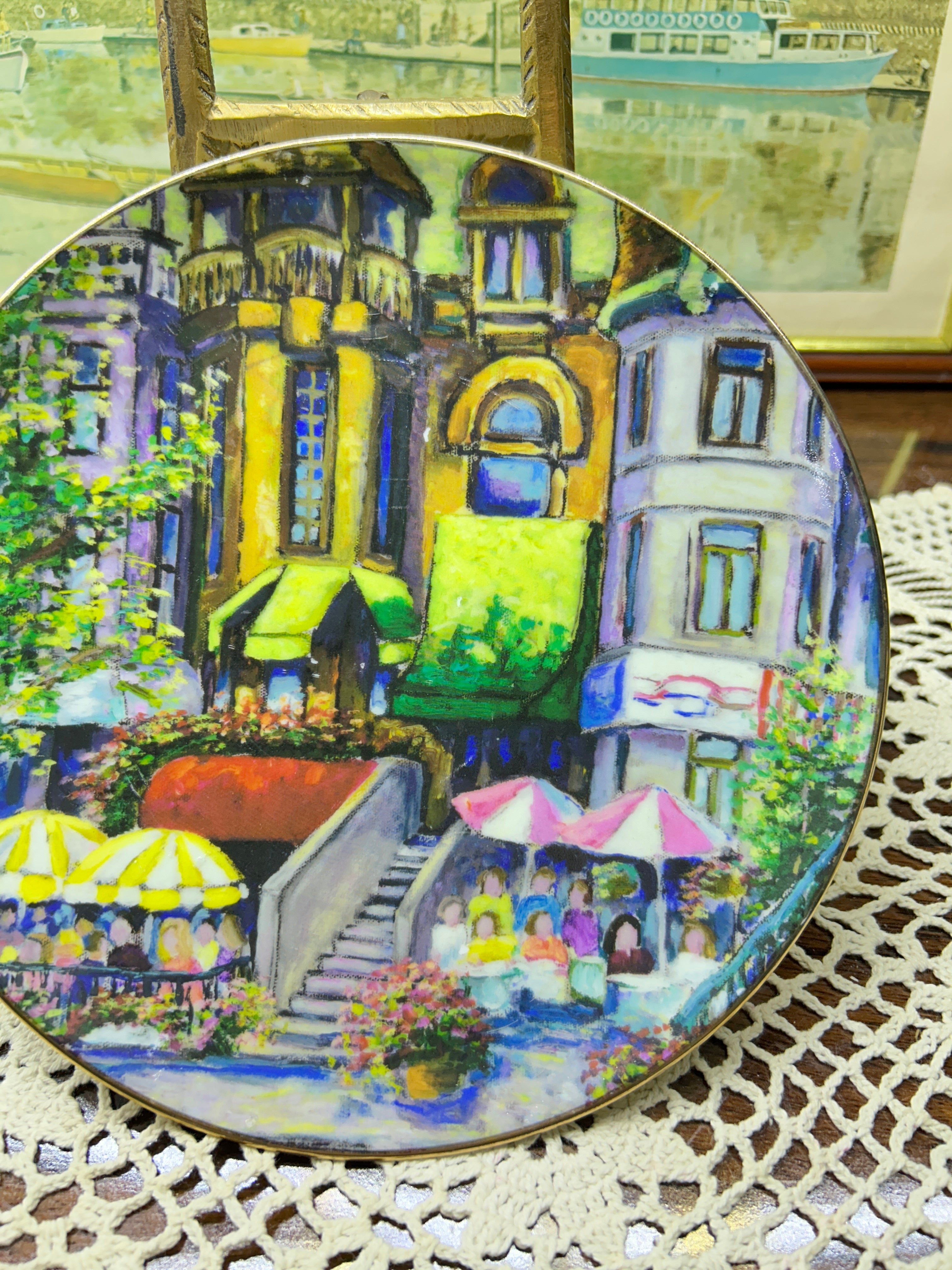 French wall decorative plate featuring a cityscape scene reminiscent of a French courtyard 7”