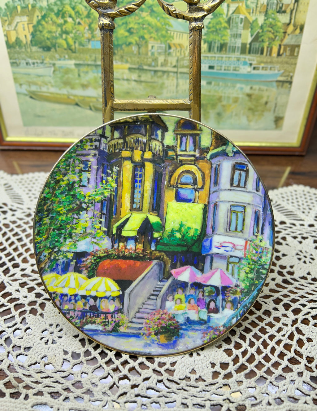 French wall decorative plate featuring a cityscape scene reminiscent of a French courtyard 7”