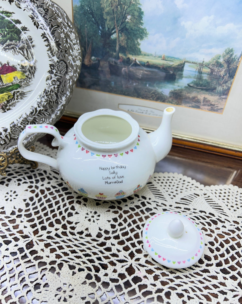 Vintage white ceramic teapot features a delicate heart garland design