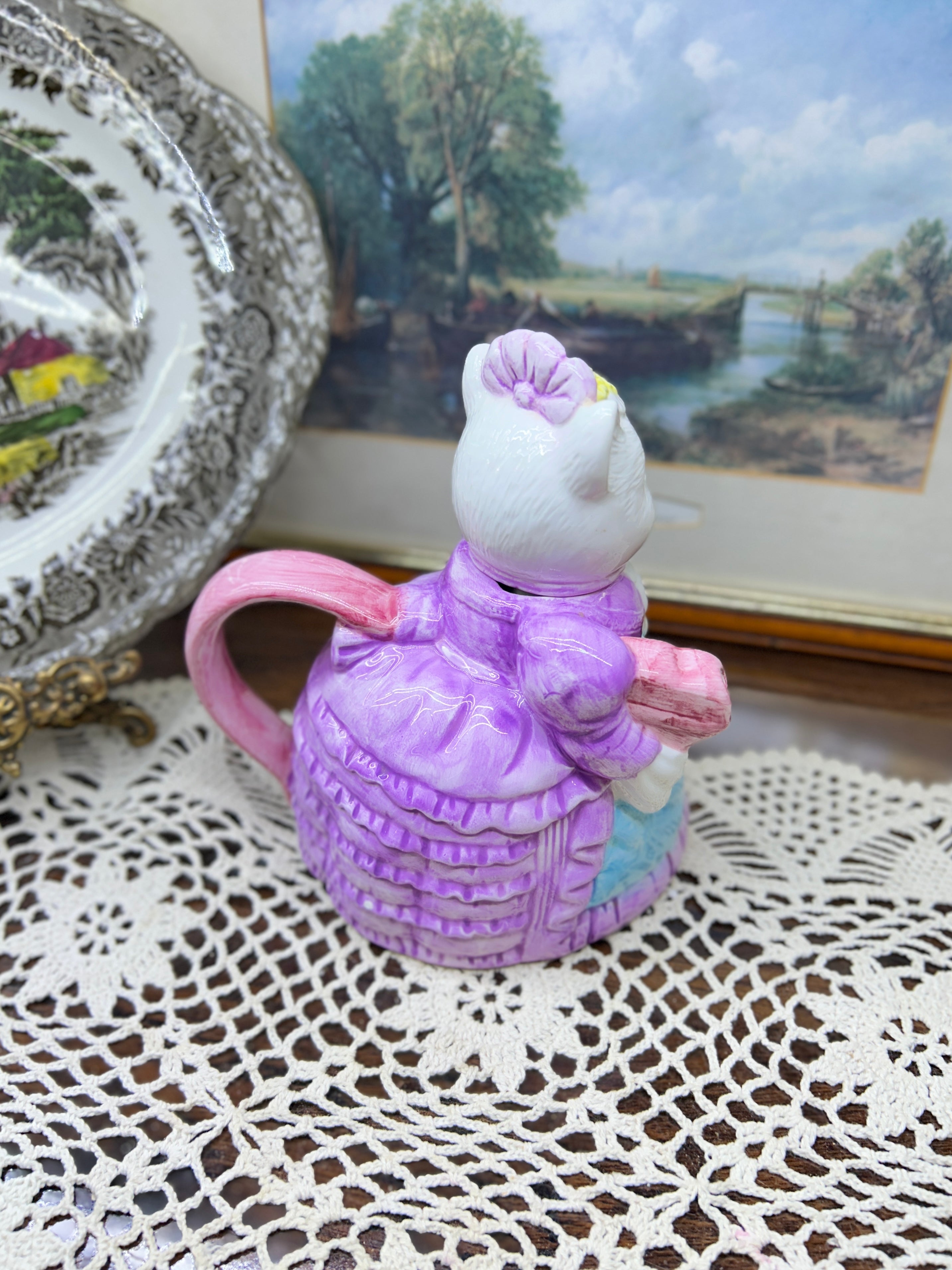 vintage ceramic novelty teapot featuring a cat dressed in a Victorian-style purple dress and bonnet 7”