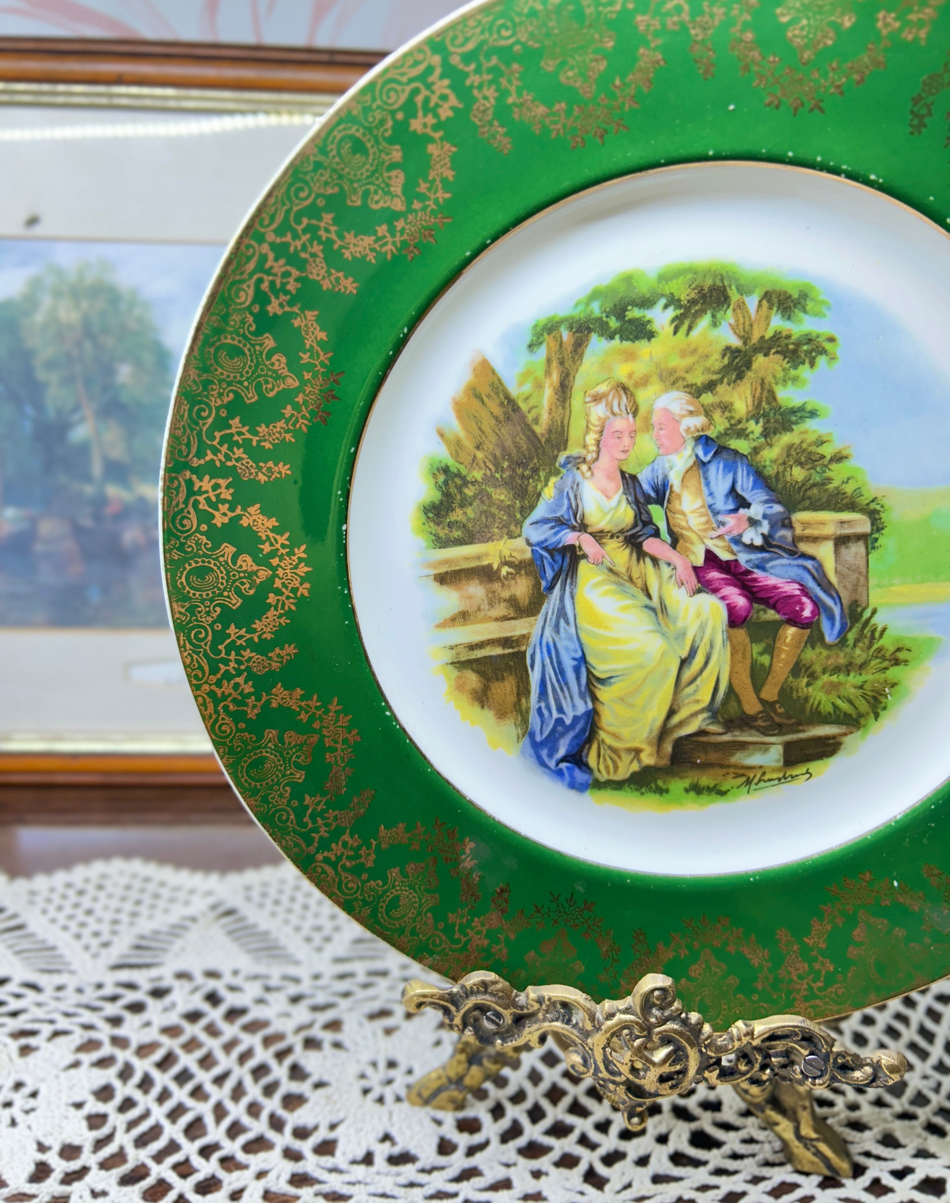 French porcelain display wall plate featuring a Fragonard courting couple scene 11”
