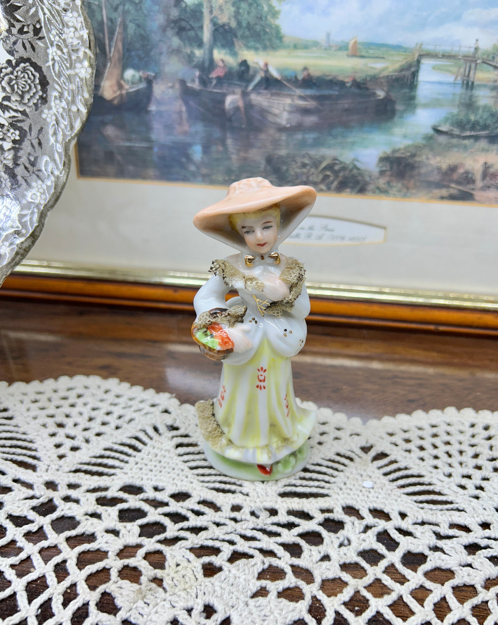 vintage Lefton figurine depicts a Victorian lady in a yellow-striped dress