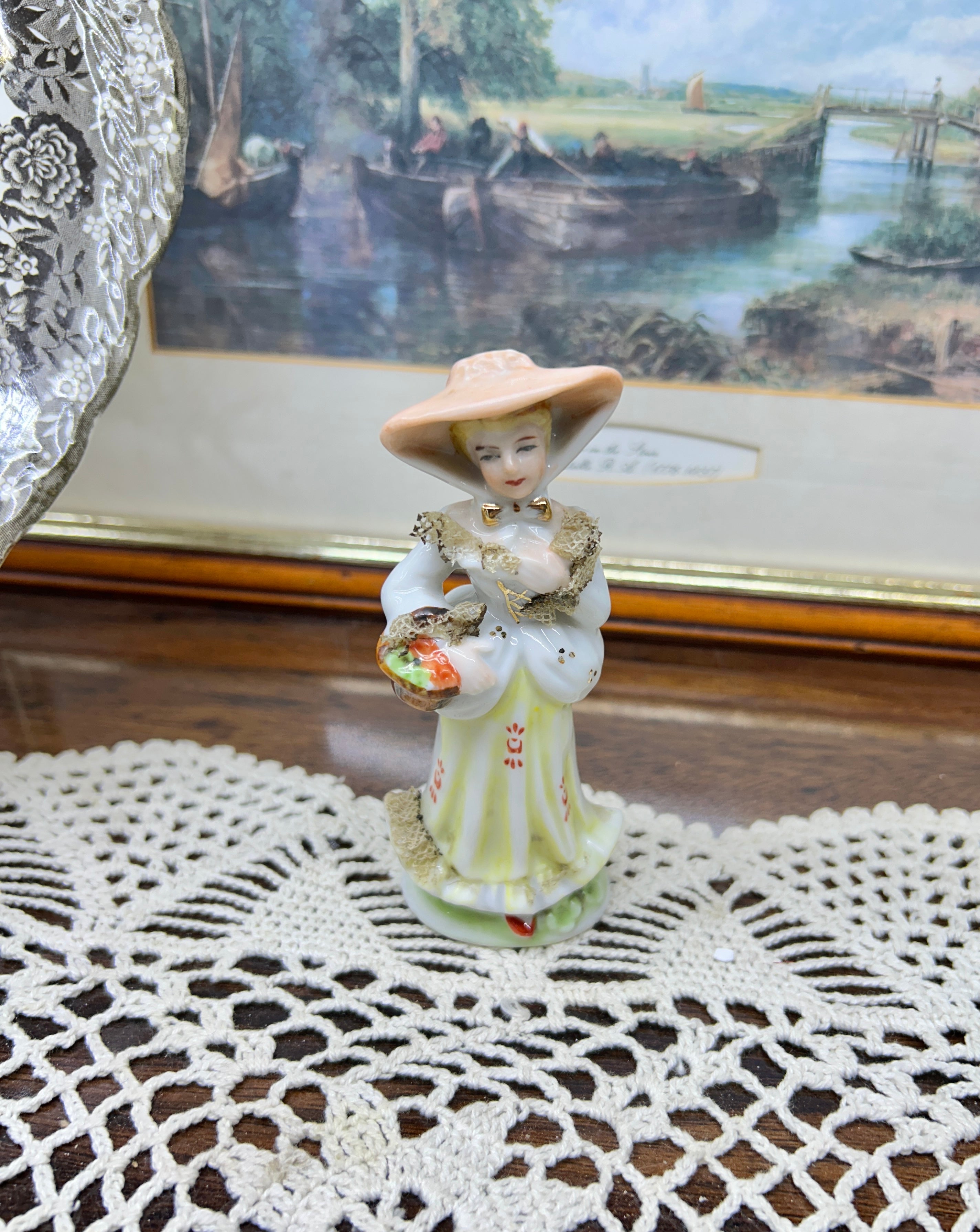 vintage Lefton figurine depicts a Victorian lady in a yellow-striped dress