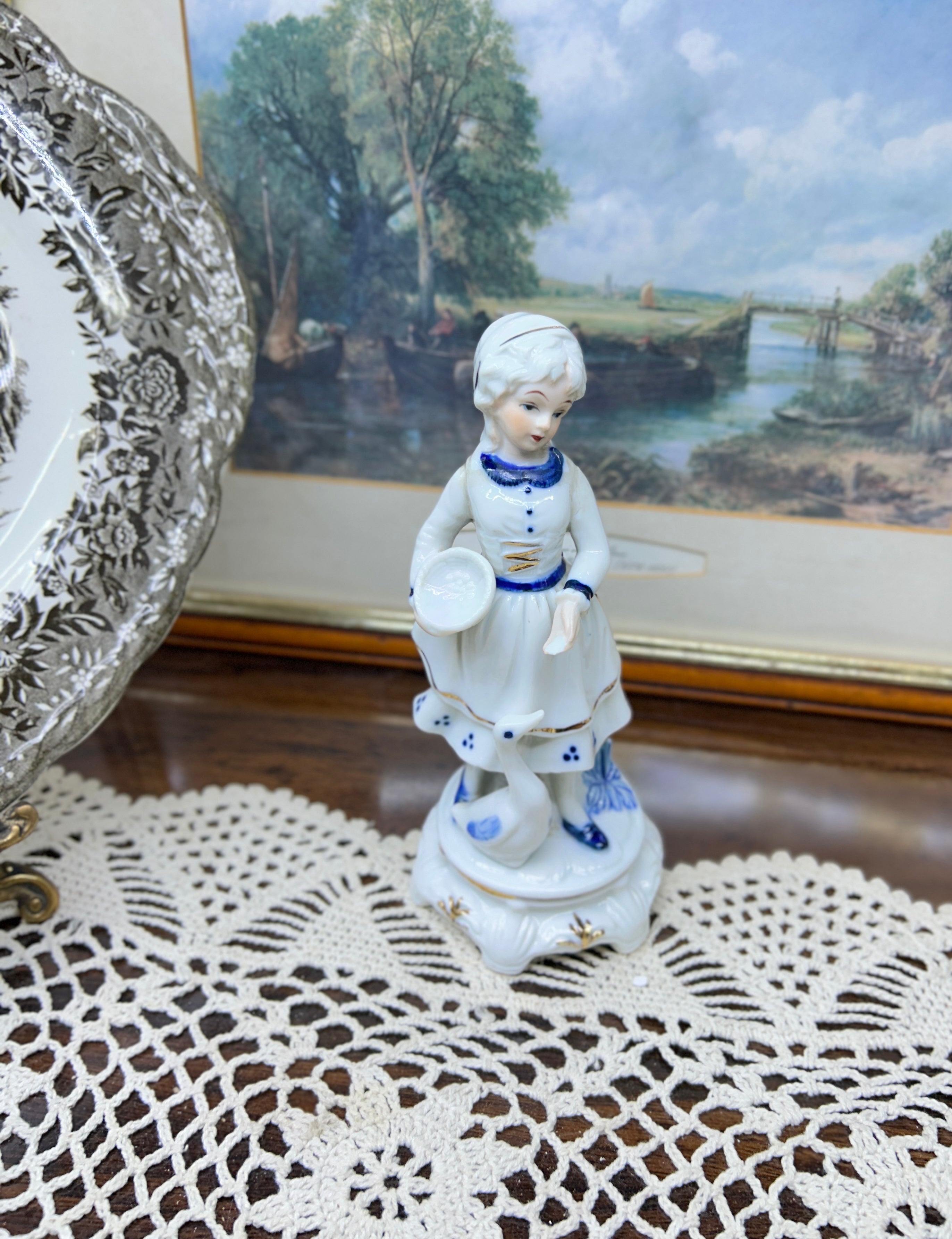 Vintage hand-painted figurine with blue accents featuring a girl with goose 6”
