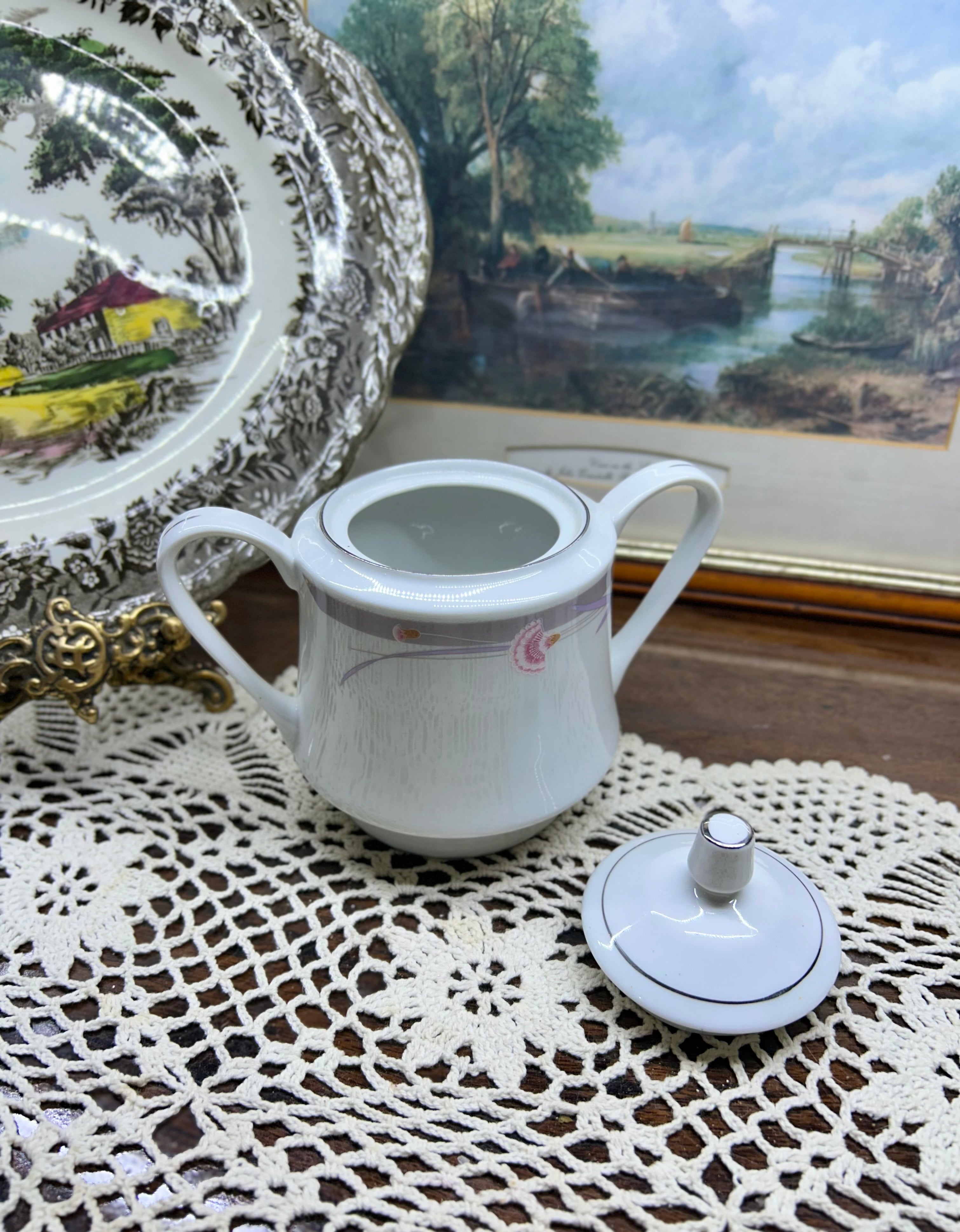 Vintage porcelain lidded sugar pot with silver rim