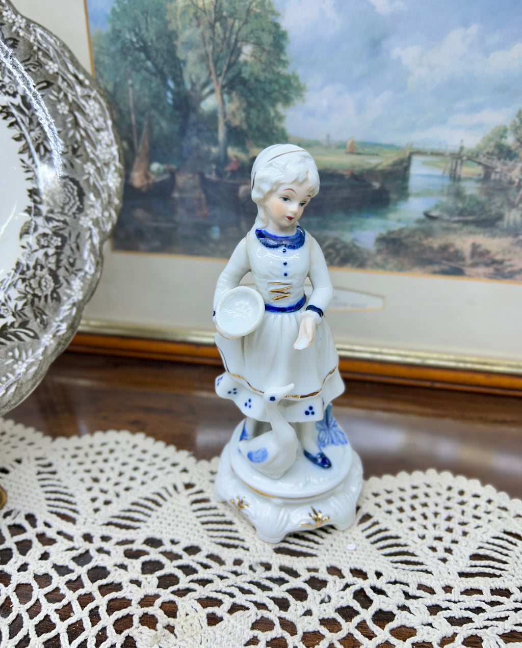 Vintage hand-painted figurine with blue accents featuring a girl with goose 6”