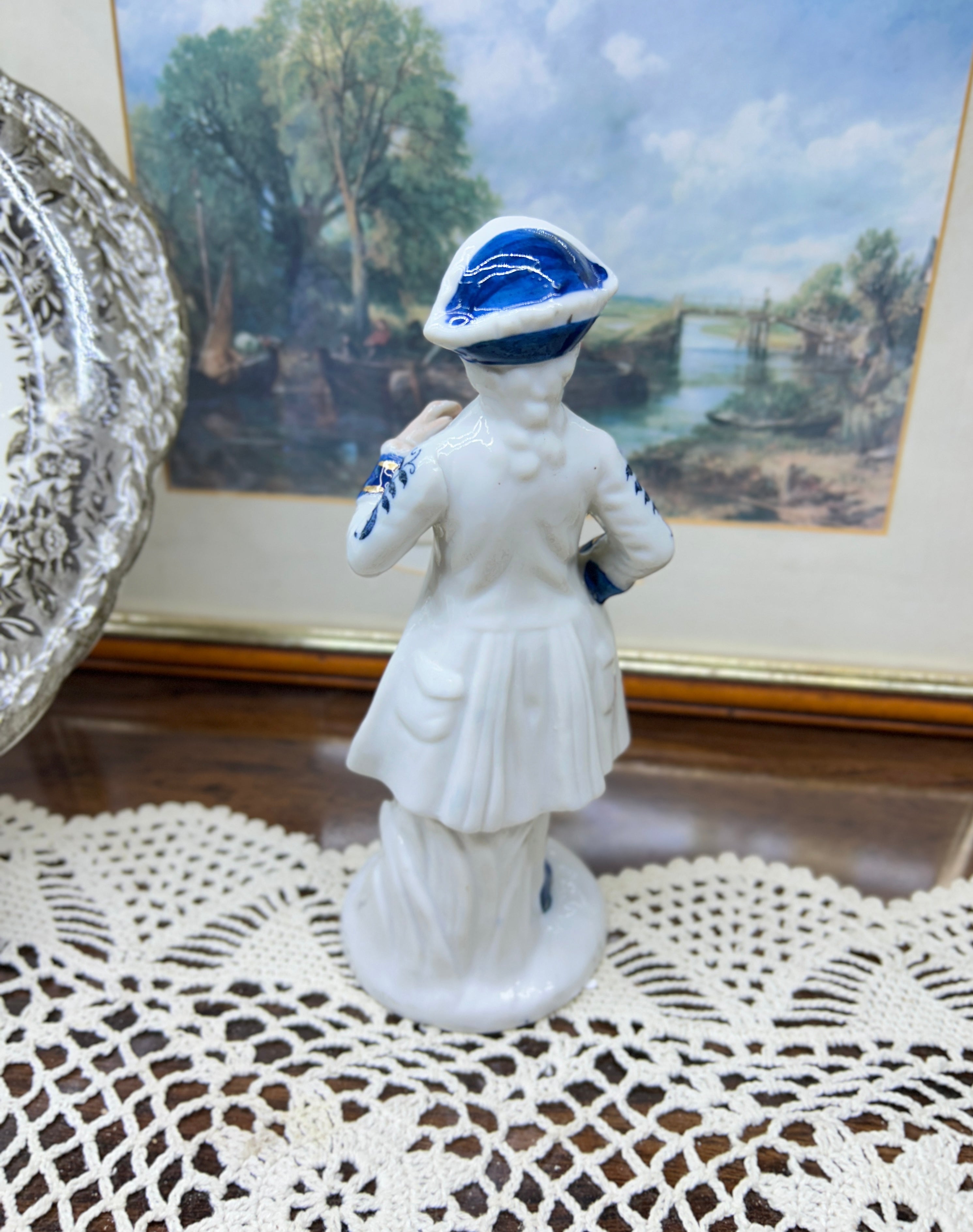 vintage porcelain  Colonial man figure — styled in blue and white with gold trim 6”