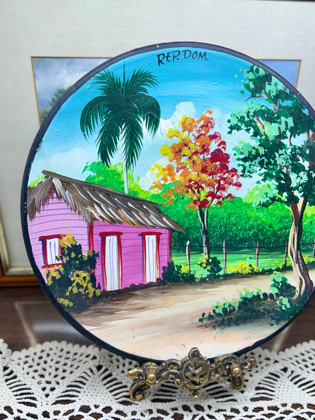 Hand-painted decorative plate featuring a vibrant Caribbean landscape from the Dominican Republic